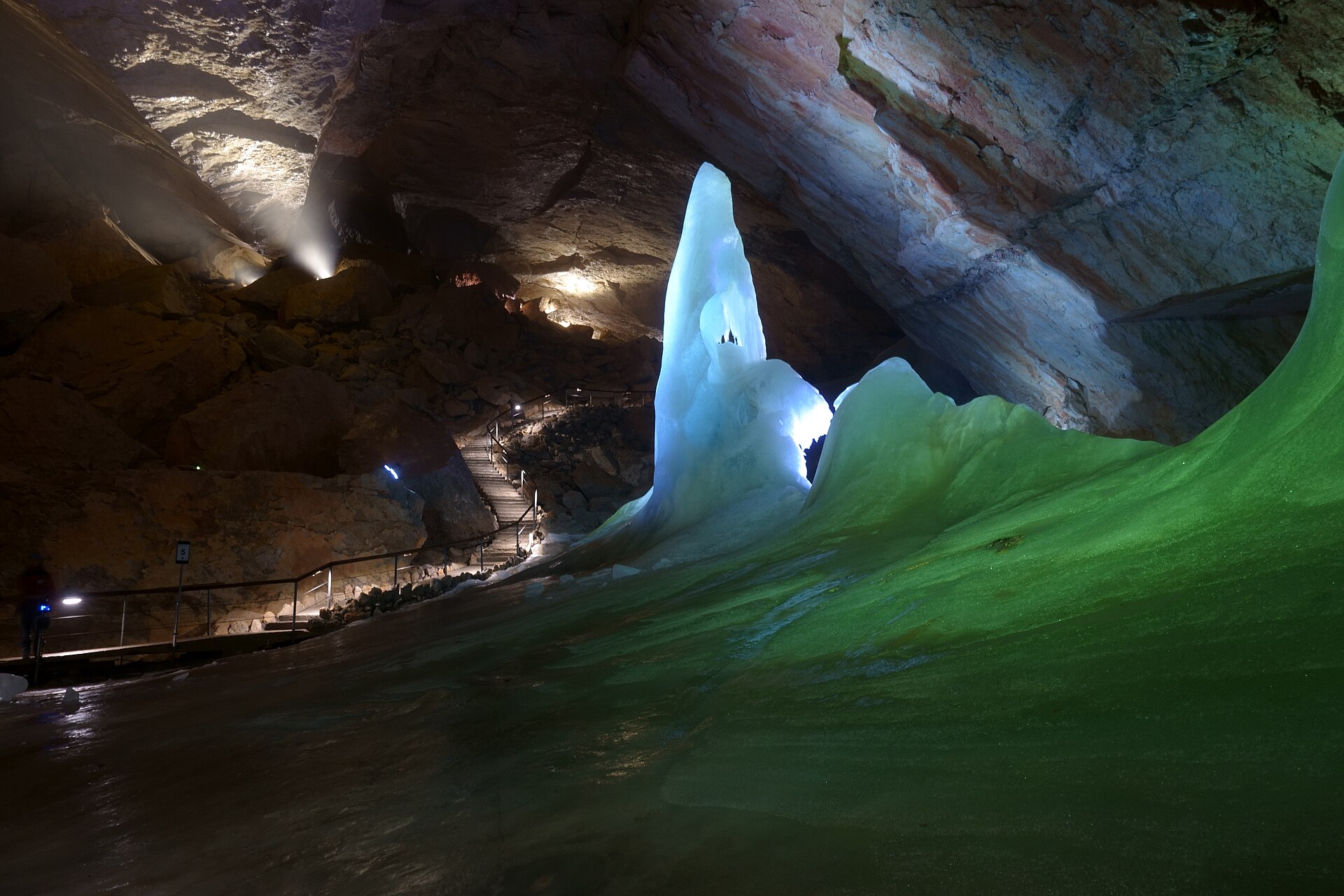 Interior of the Dachstein Giant Ice Cave showing the Parsifal Dome with massive ice formations glowing blue and white under lighting