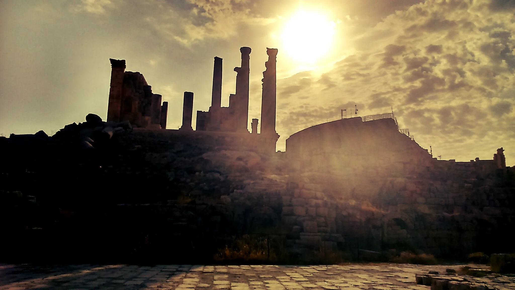 View of the Amman Citadel ruins on the hilltop, with columns and ancient stonework against the blue sky