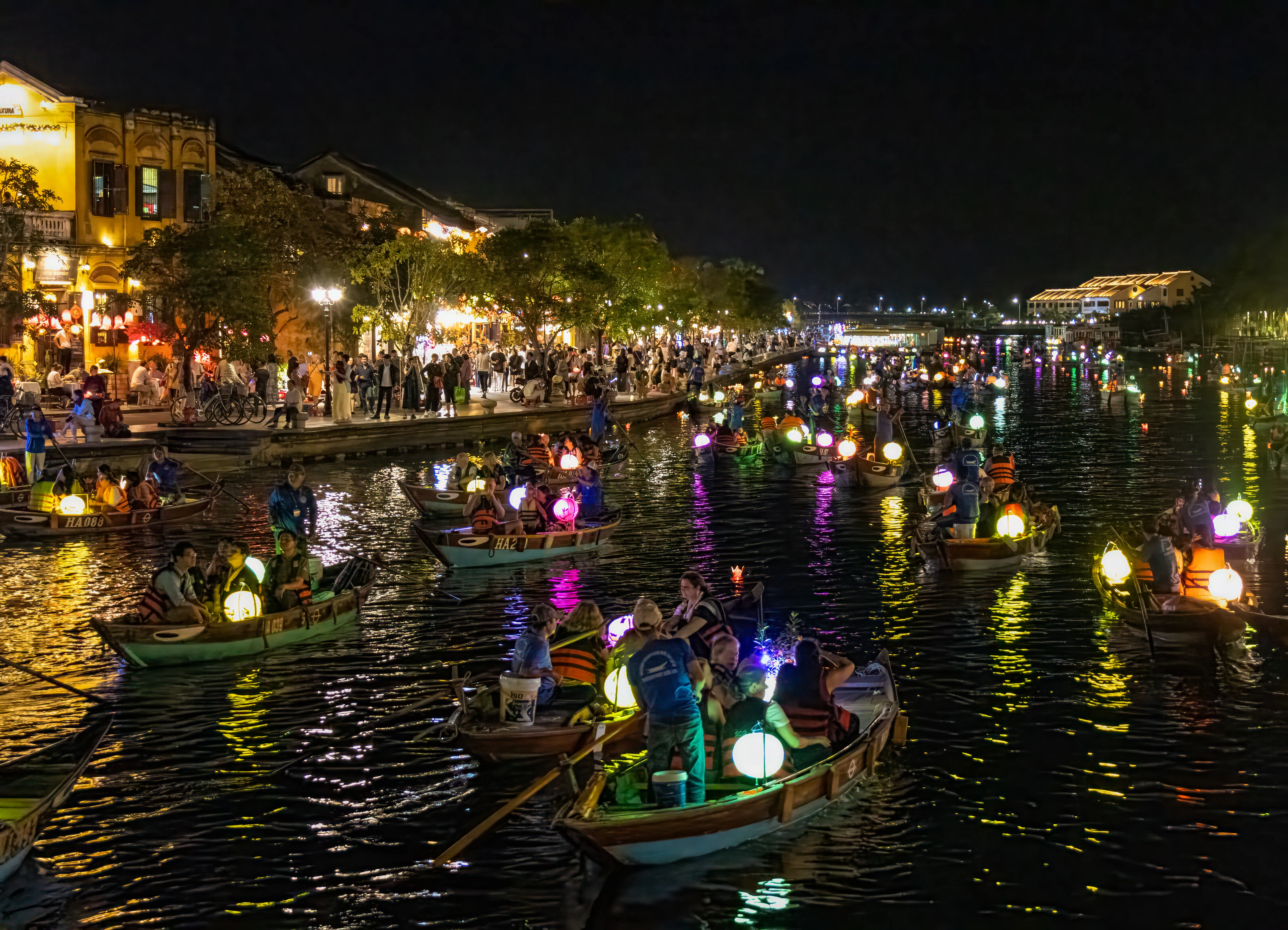 Panoramic view of Hoi An Ancient Town's yellow-washed merchant houses lining the Thu Bon River, Hoi An, Vietnam