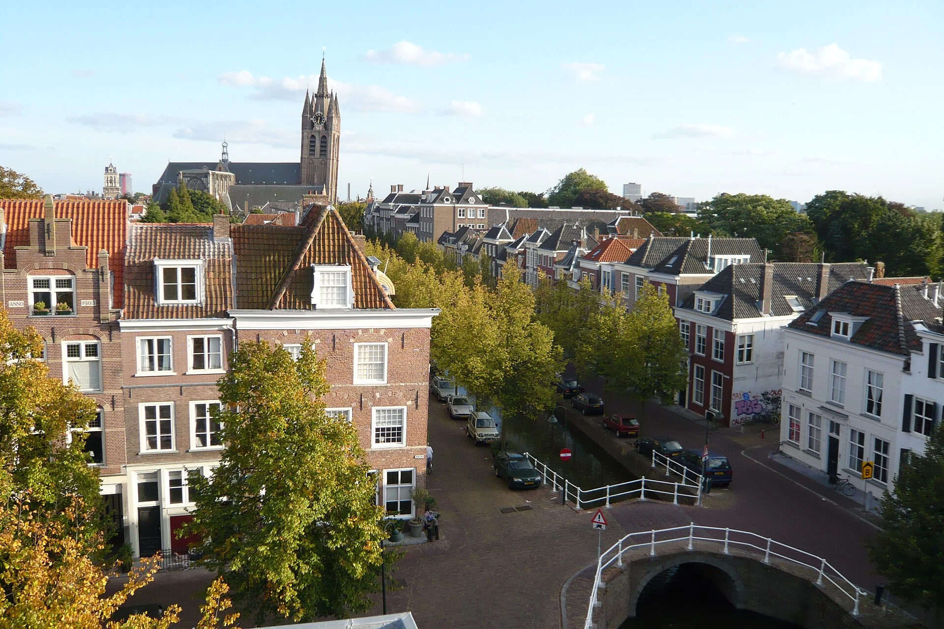 Rooftop view across Delft toward the leaning Oude Kerk tower