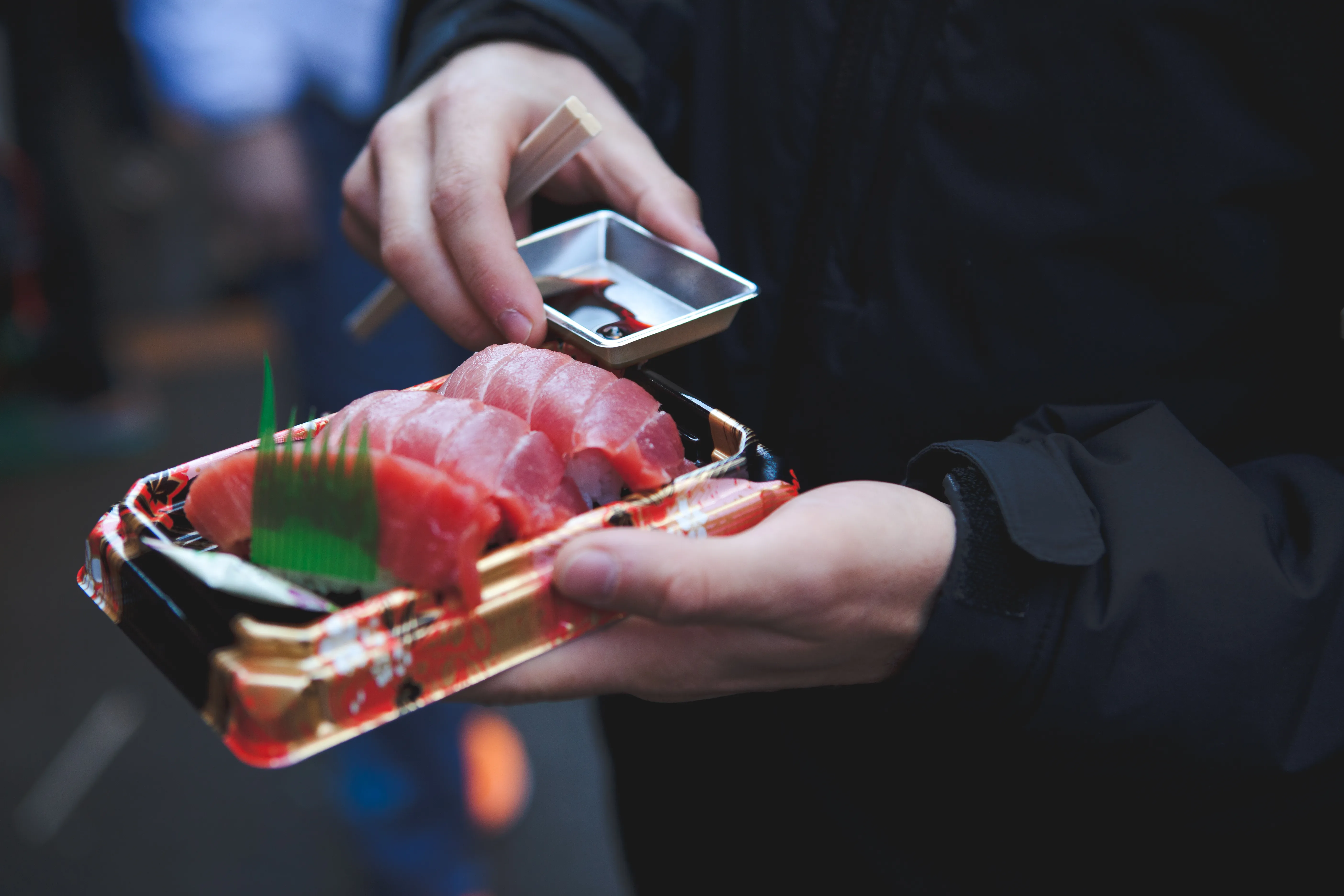 Slices of fresh tuna and other sashimi laid out for sale at a Tsukiji market stall in Tokyo
