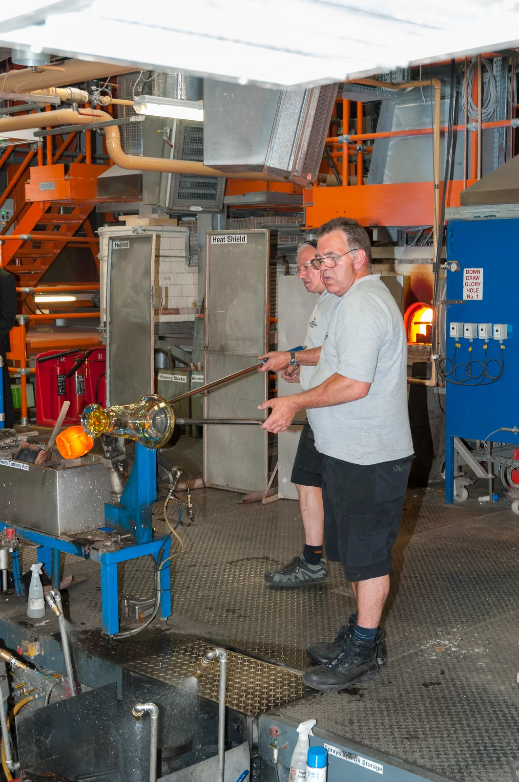 A craftsman blowing a glass vase on the factory tour at the House of Waterford Crystal
