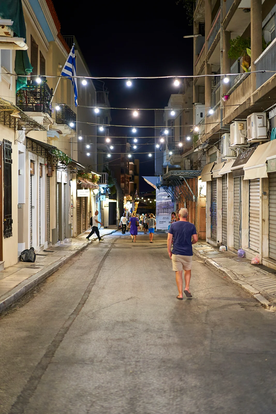 Adrianou Street in Plaka lit up at night with tavernas and diners