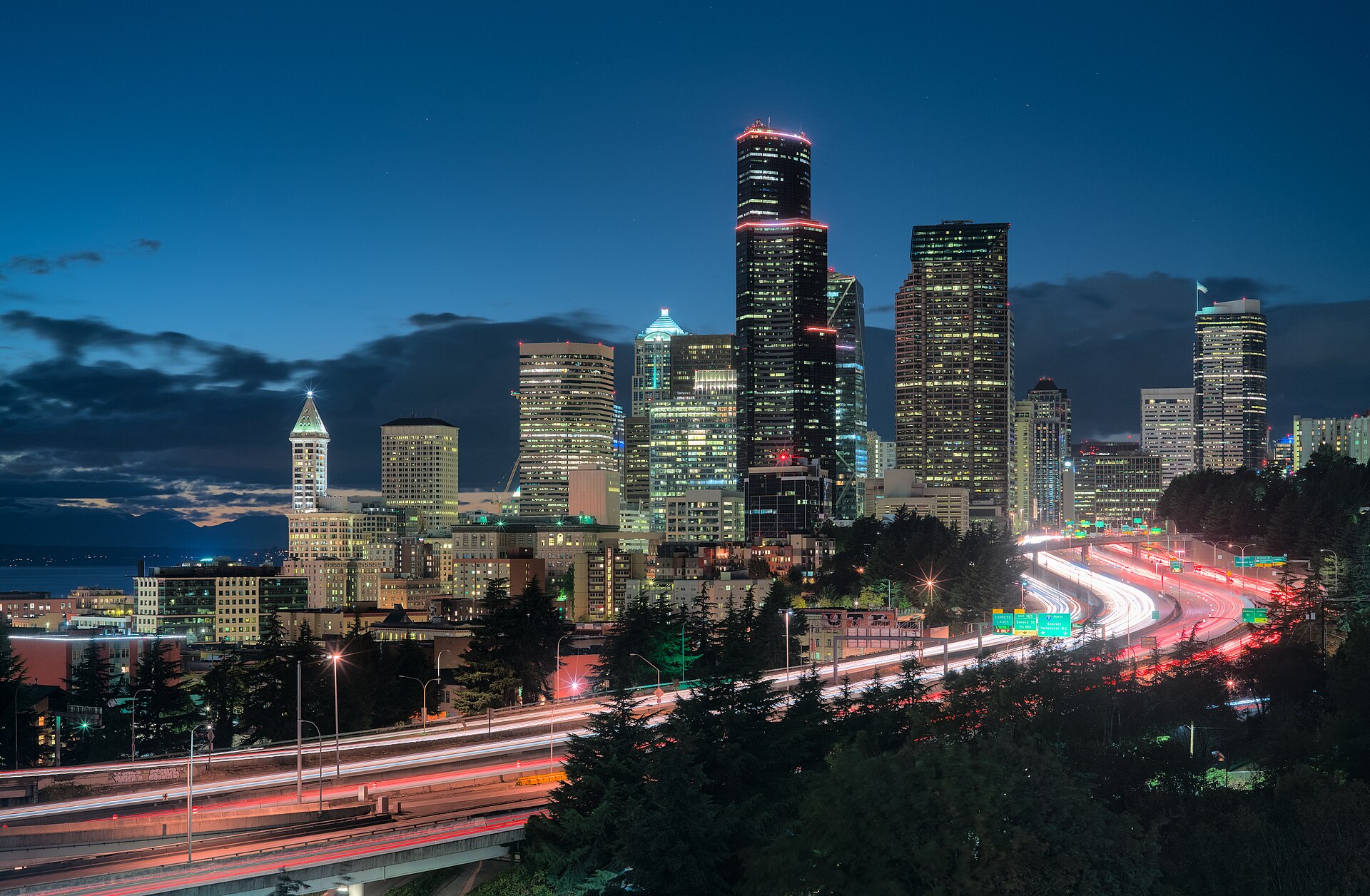 Seattle skyline at dusk from Dr. Jose Rizal Park with Interstate 5 in the foreground