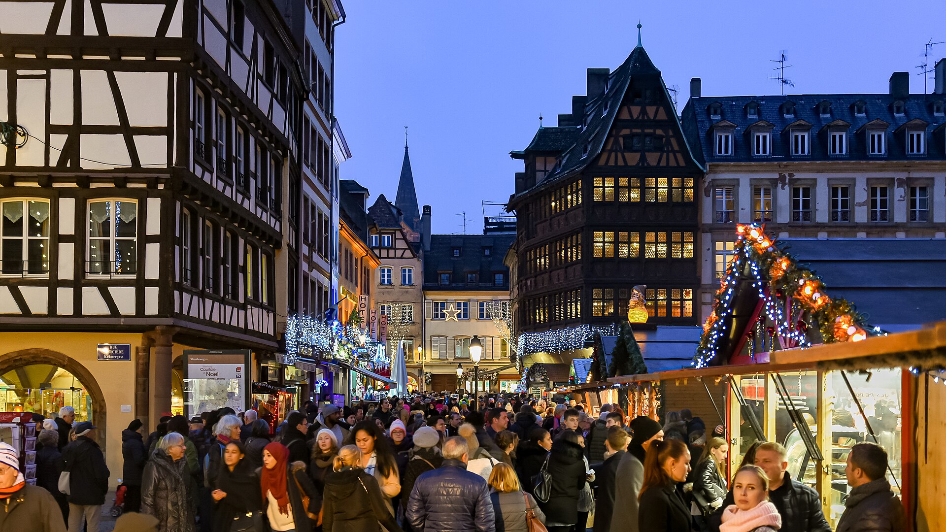 Strasbourg Christmas market stalls illuminated at night near the cathedral