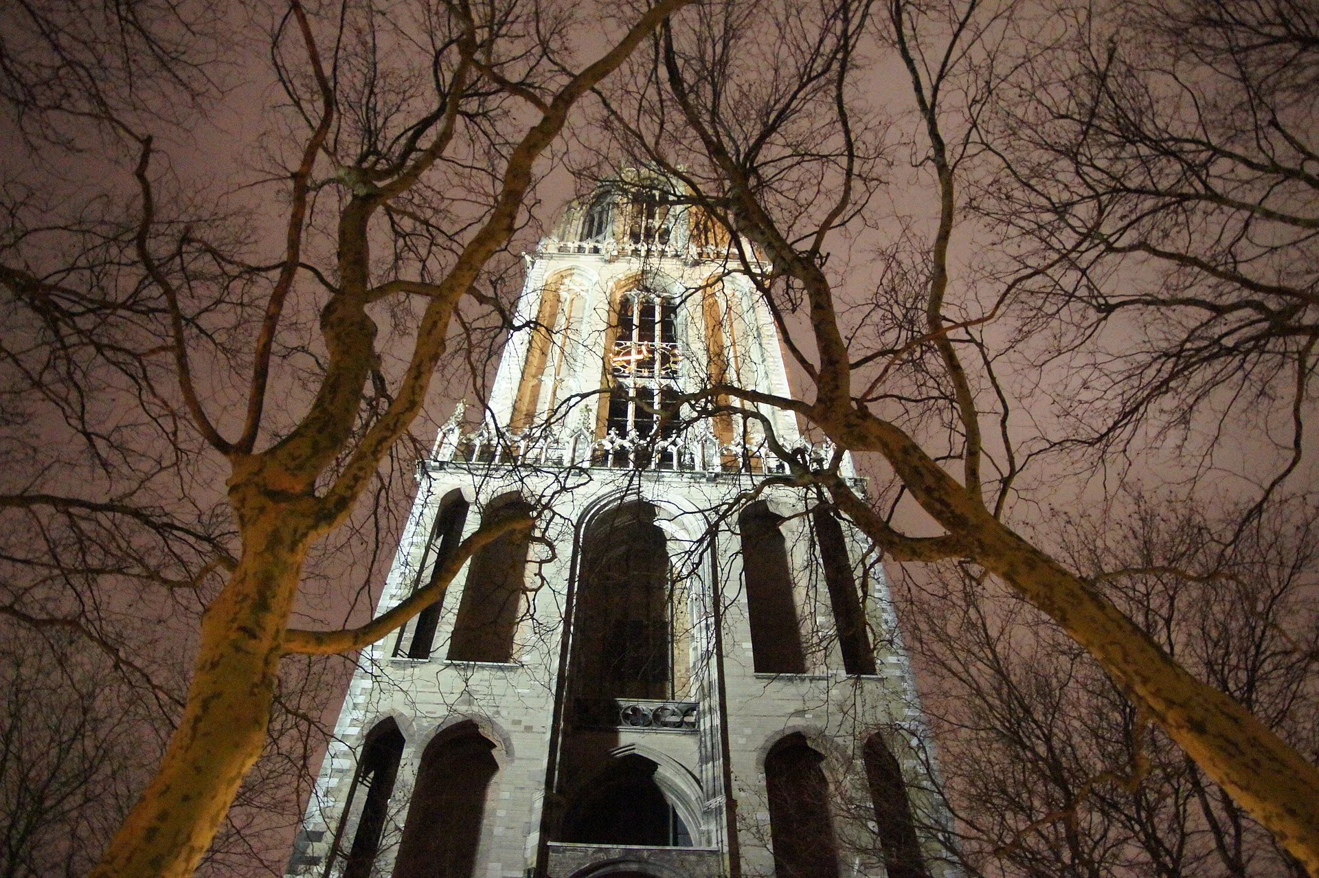 The floodlit Dom Tower of Utrecht against the night sky