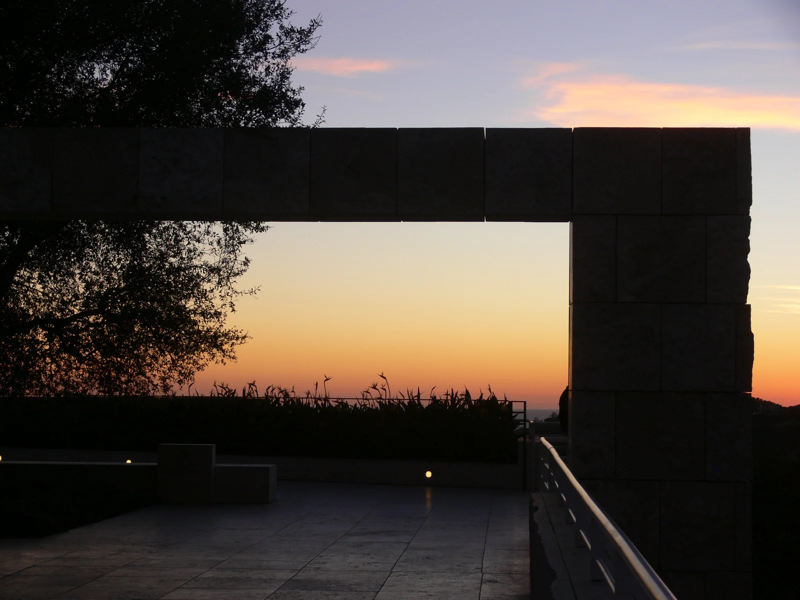 Curved travertine facade of the Getty Center glowing at sunset