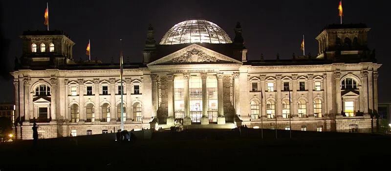 Berlin Reichstag building with its glass dome reflecting evening light