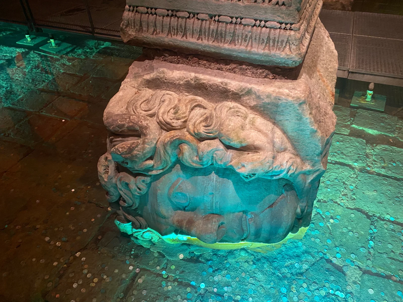 Carved Medusa head set sideways at the base of a column in the Basilica Cistern