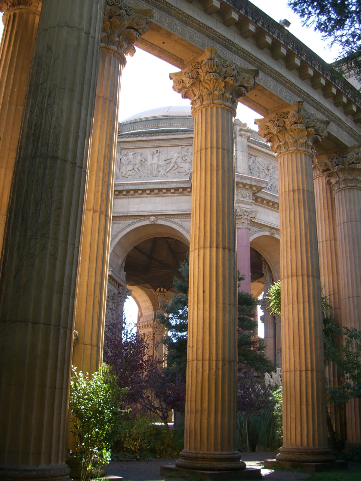 The curved Corinthian colonnade of the Palace of Fine Arts sweeping toward the domed rotunda under a clear sky