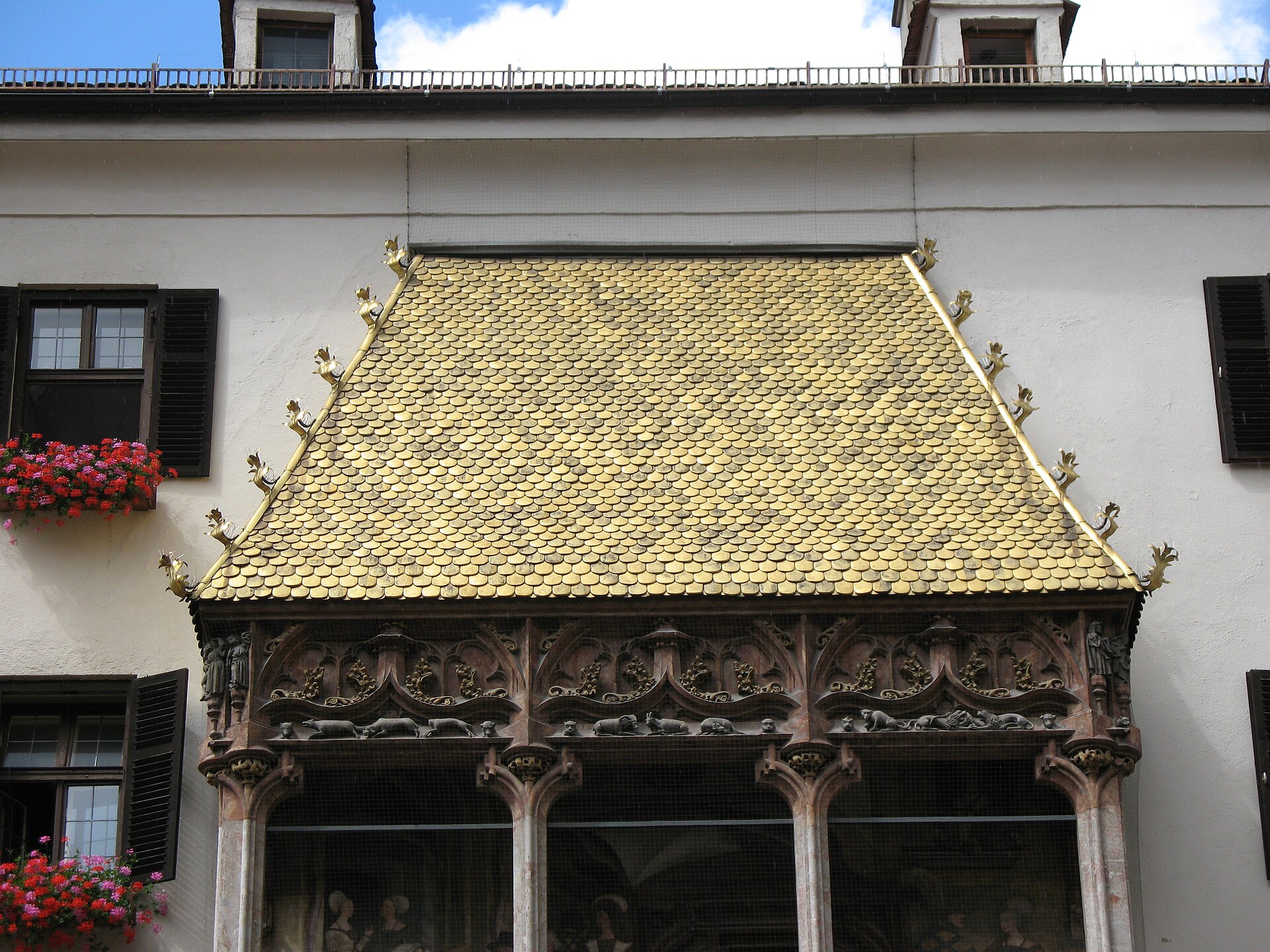 The Goldenes Dachl (Golden Roof) in Innsbruck showing the gilded copper-tiled balcony with ornate Renaissance reliefs on the facade