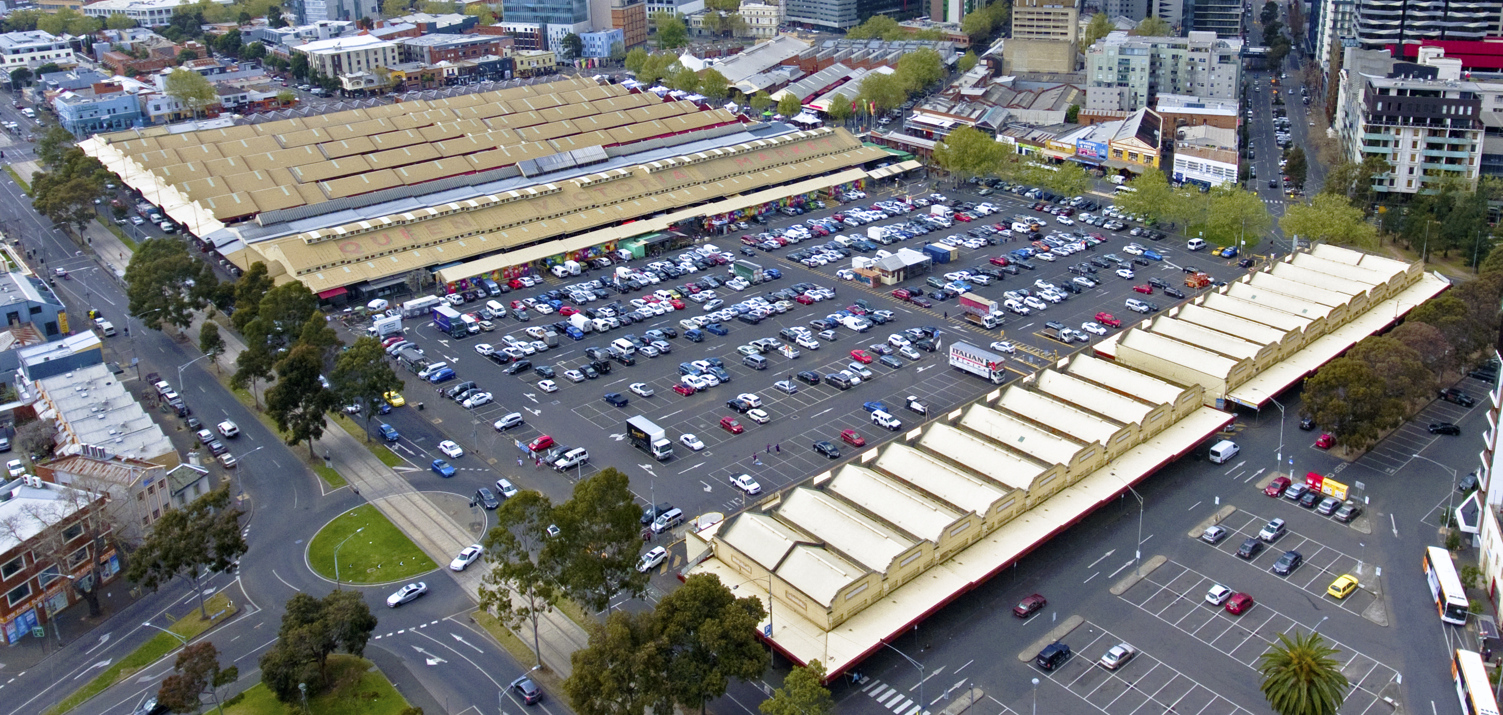Queen Victoria Market in Melbourne with open-air stalls and the historic market sheds