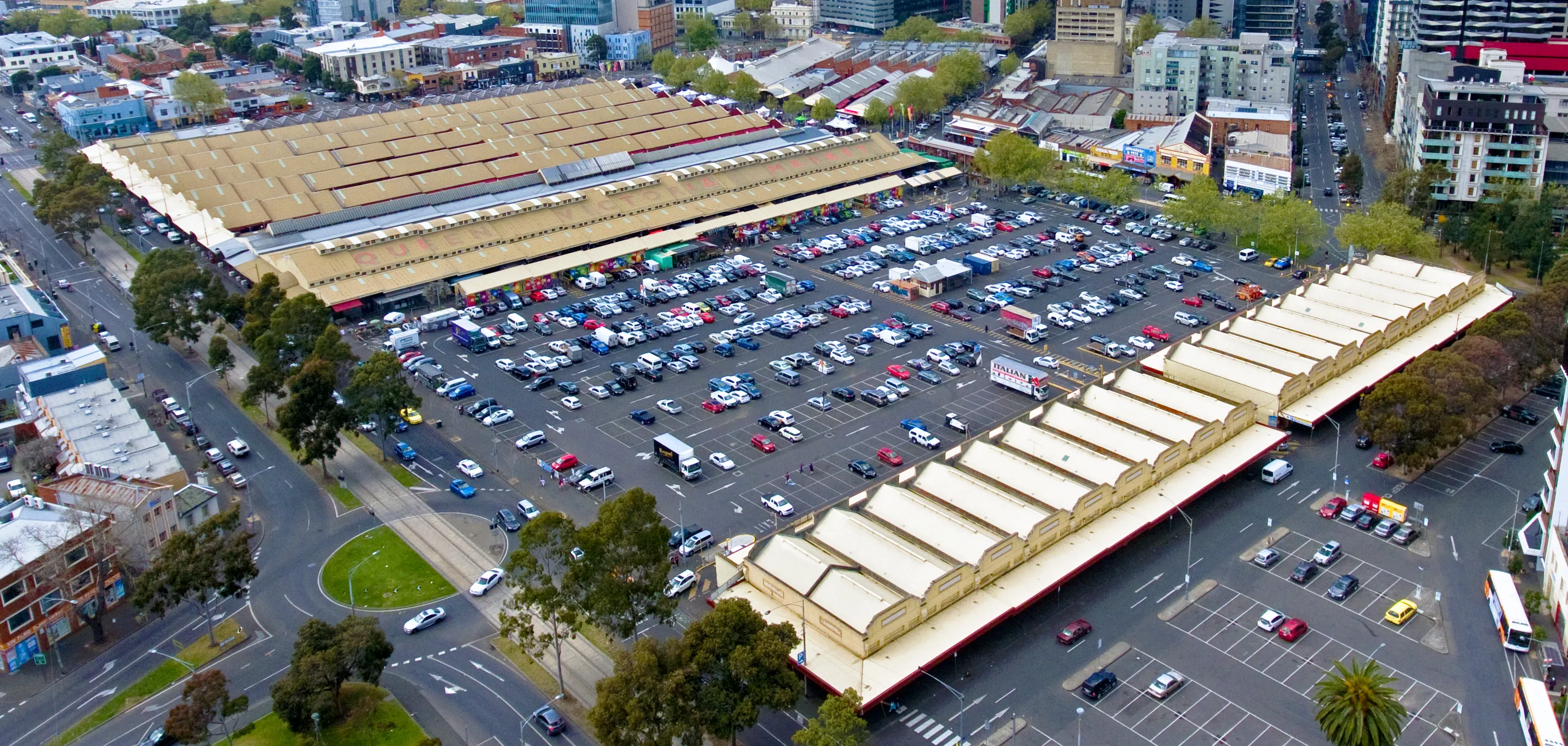 Queen Victoria Market in Melbourne with open-air stalls and the historic market sheds
