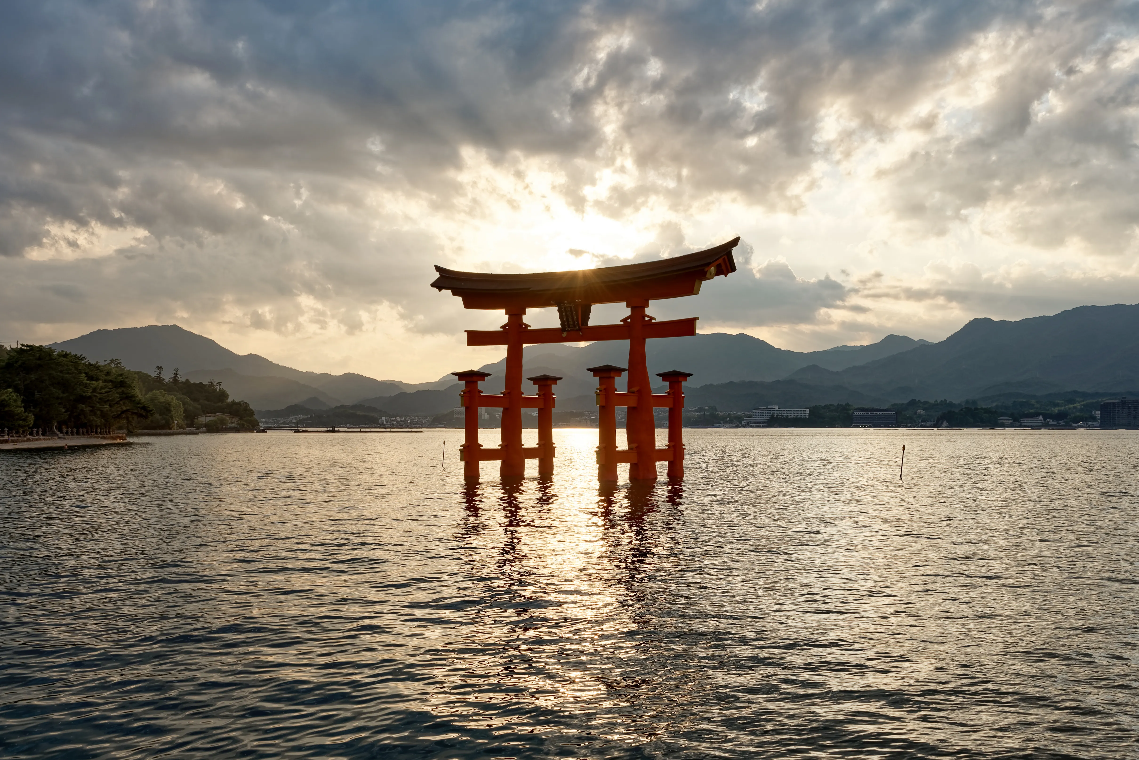 The floating vermilion torii gate of Itsukushima Shrine at sunset off Miyajima island