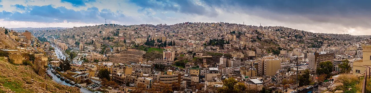 Panoramic view of Amman's white-stone buildings spreading across multiple hills in Jordan