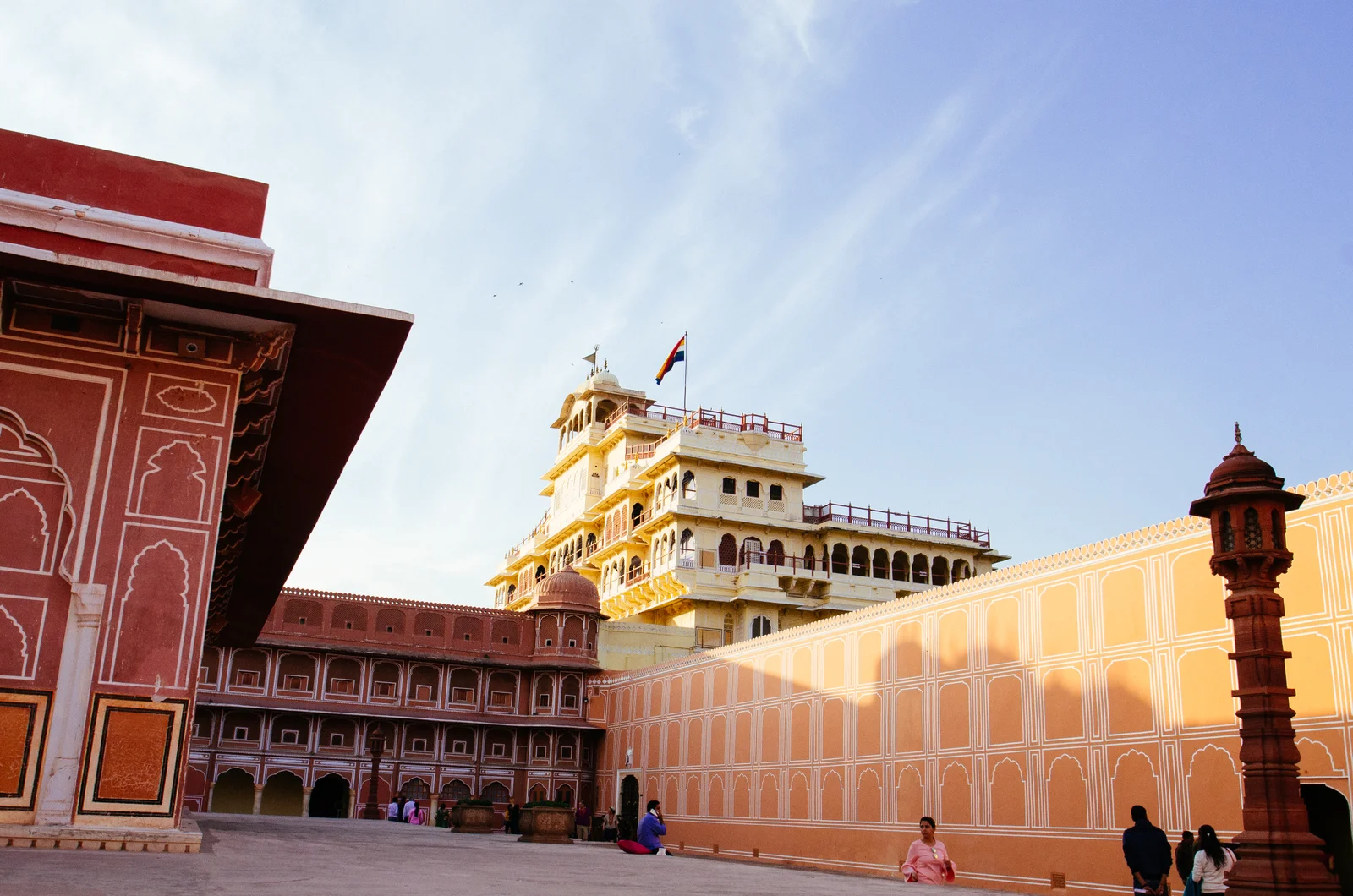 The seven-storey Chandra Mahal rising above the salmon-pink courtyard walls of Jaipur's City Palace, an Indian flag flying from its roof