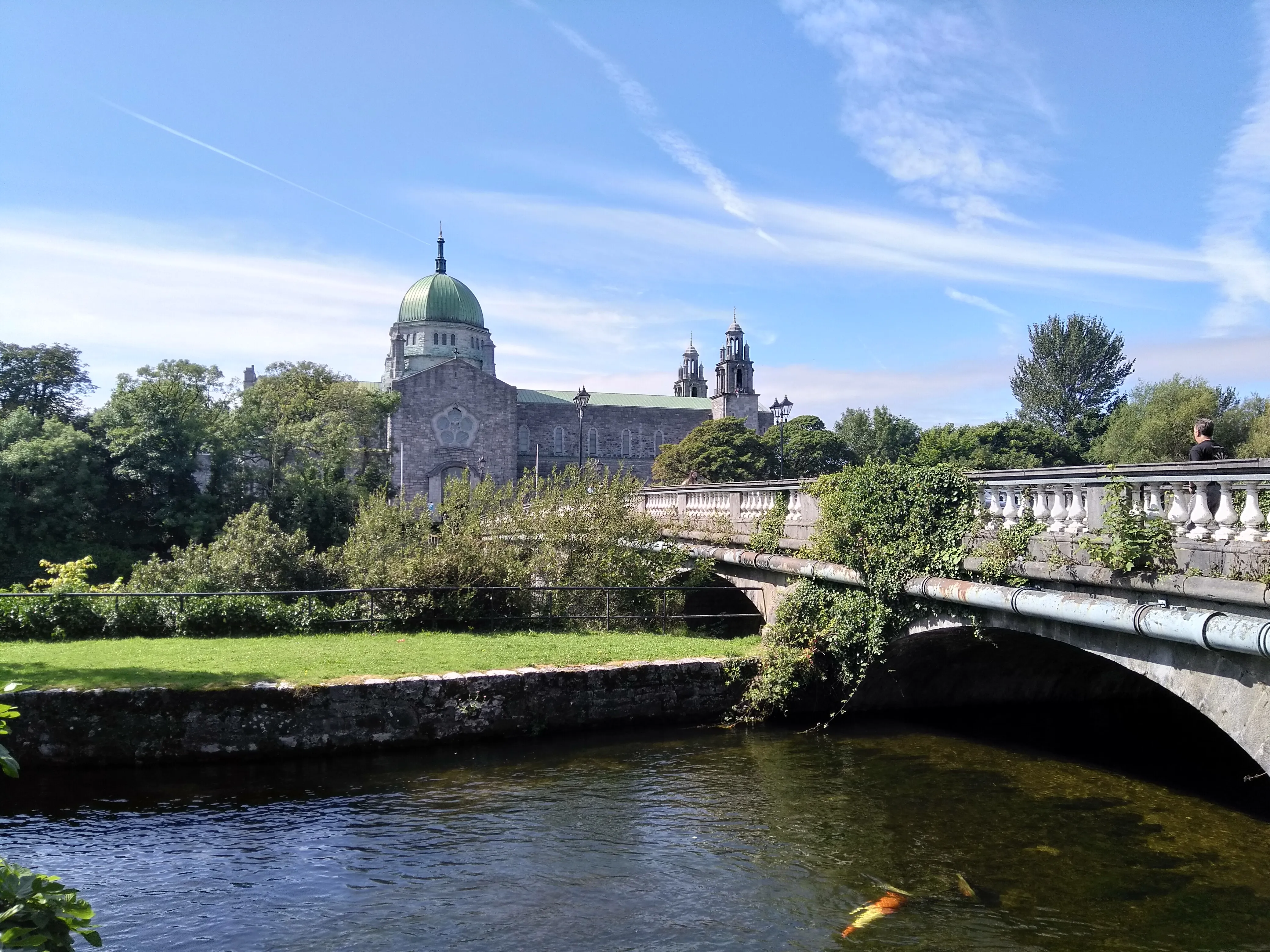 Galway Cathedral seen across the River Corrib with the Salmon Weir Bridge in the foreground