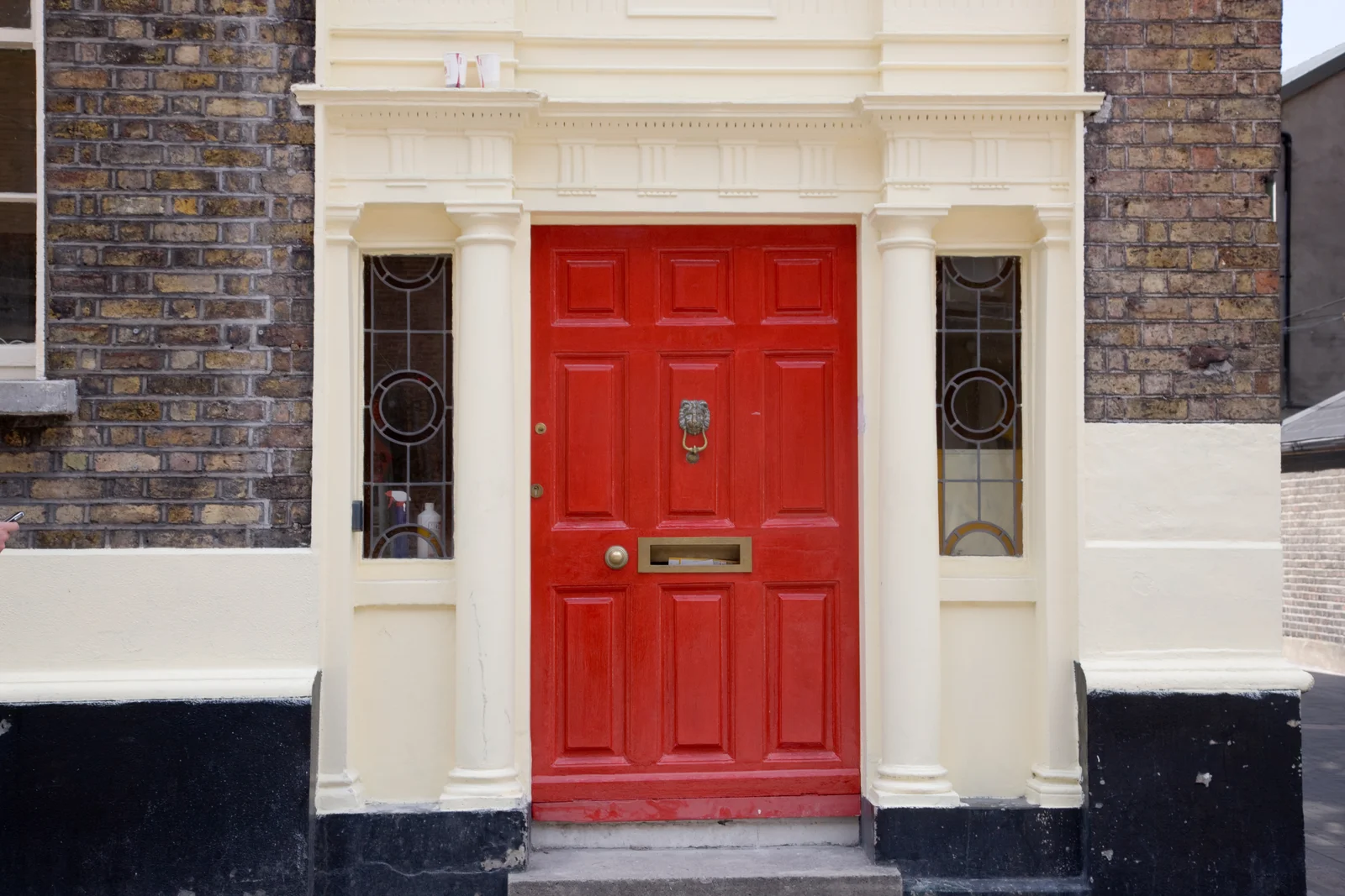A bright red Georgian front door with a fanlight and brass fittings on Harcourt Street in Dublin