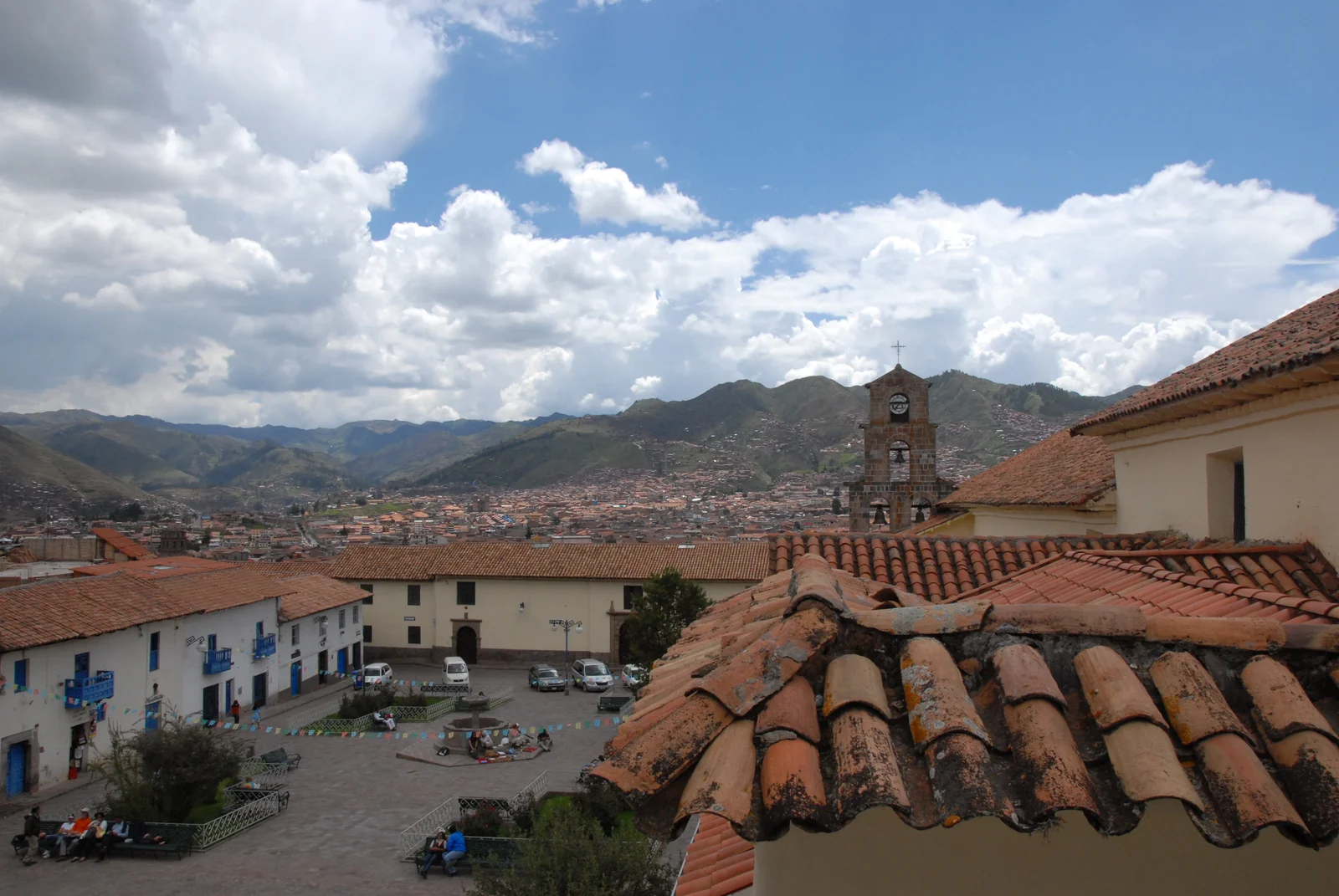 Terracotta-tiled rooftops of the San Blas artisan quarter climbing the hillside above central Cusco, Peru