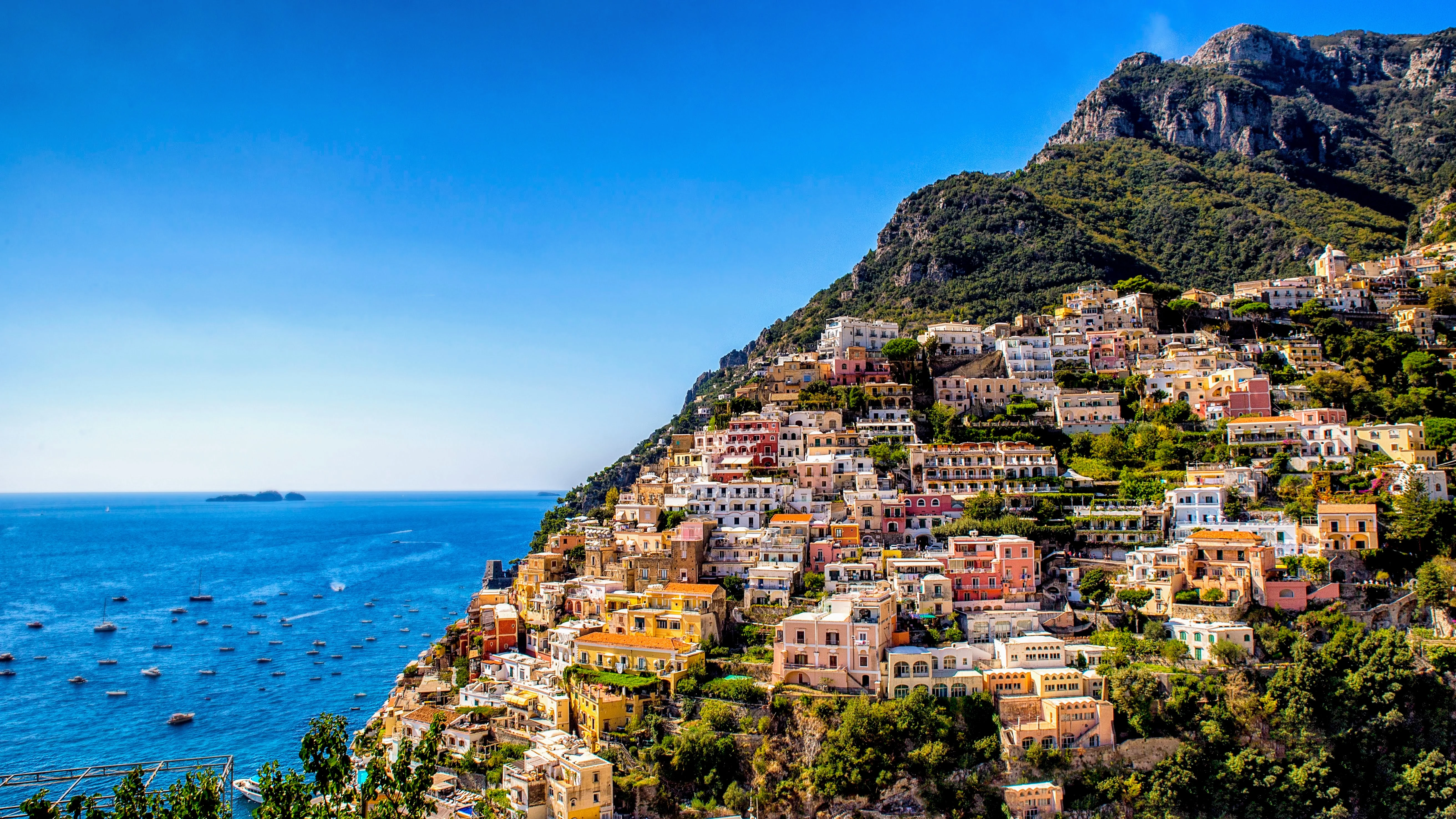 Panorama of Positano's pastel houses cascading down the cliff to Spiaggia Grande beach
