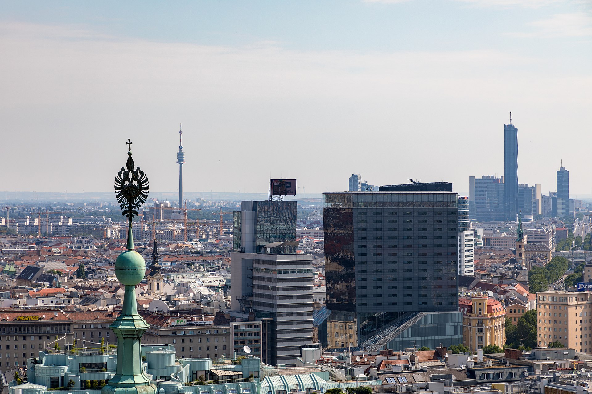 Panoramic view of Vienna's skyline from the south tower of St. Stephen's Cathedral, with rooftops and church spires stretching to the horizon