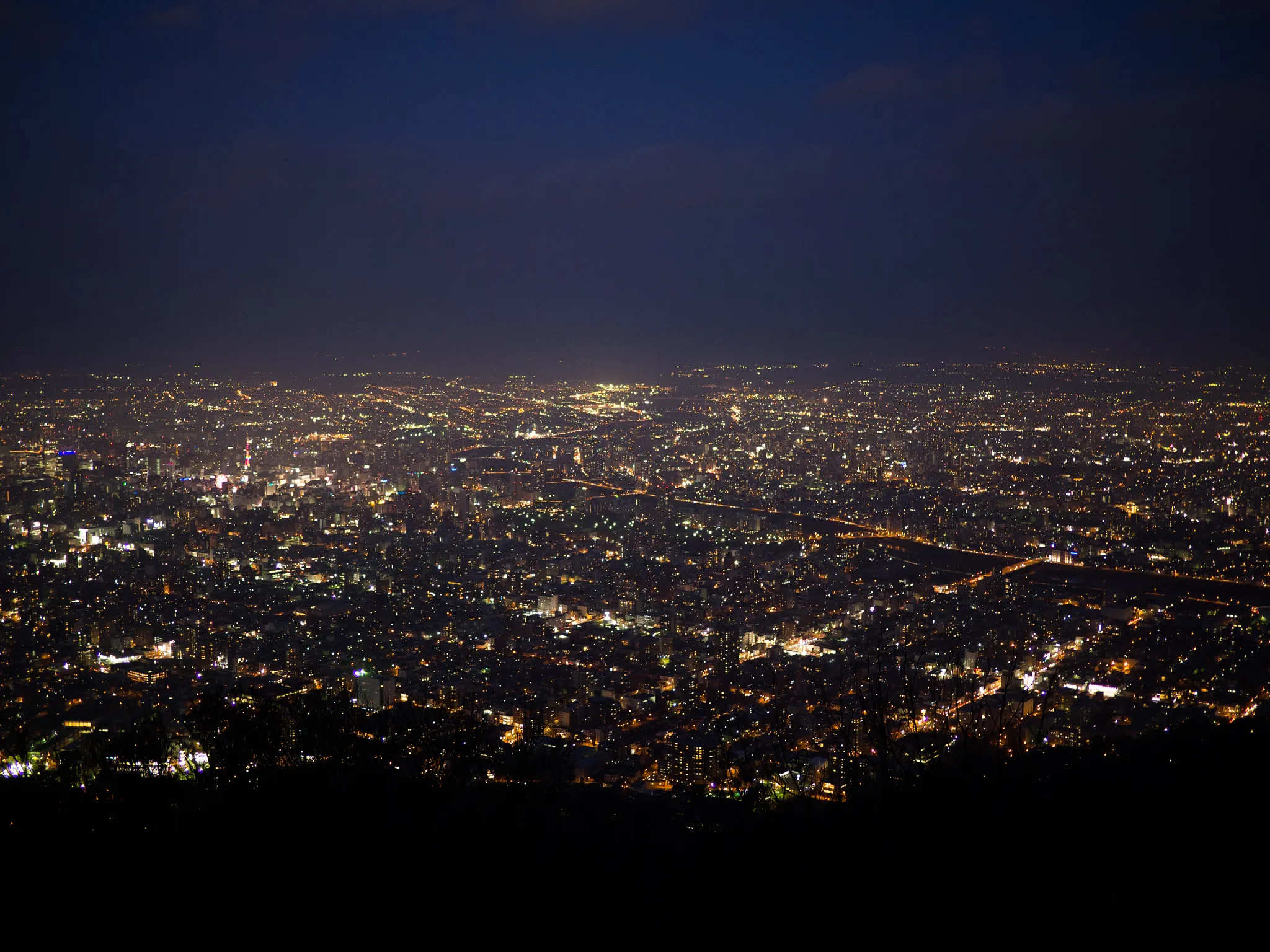 The night lights of Sapporo spread across the Ishikari plain seen from the Mount Moiwa observatory