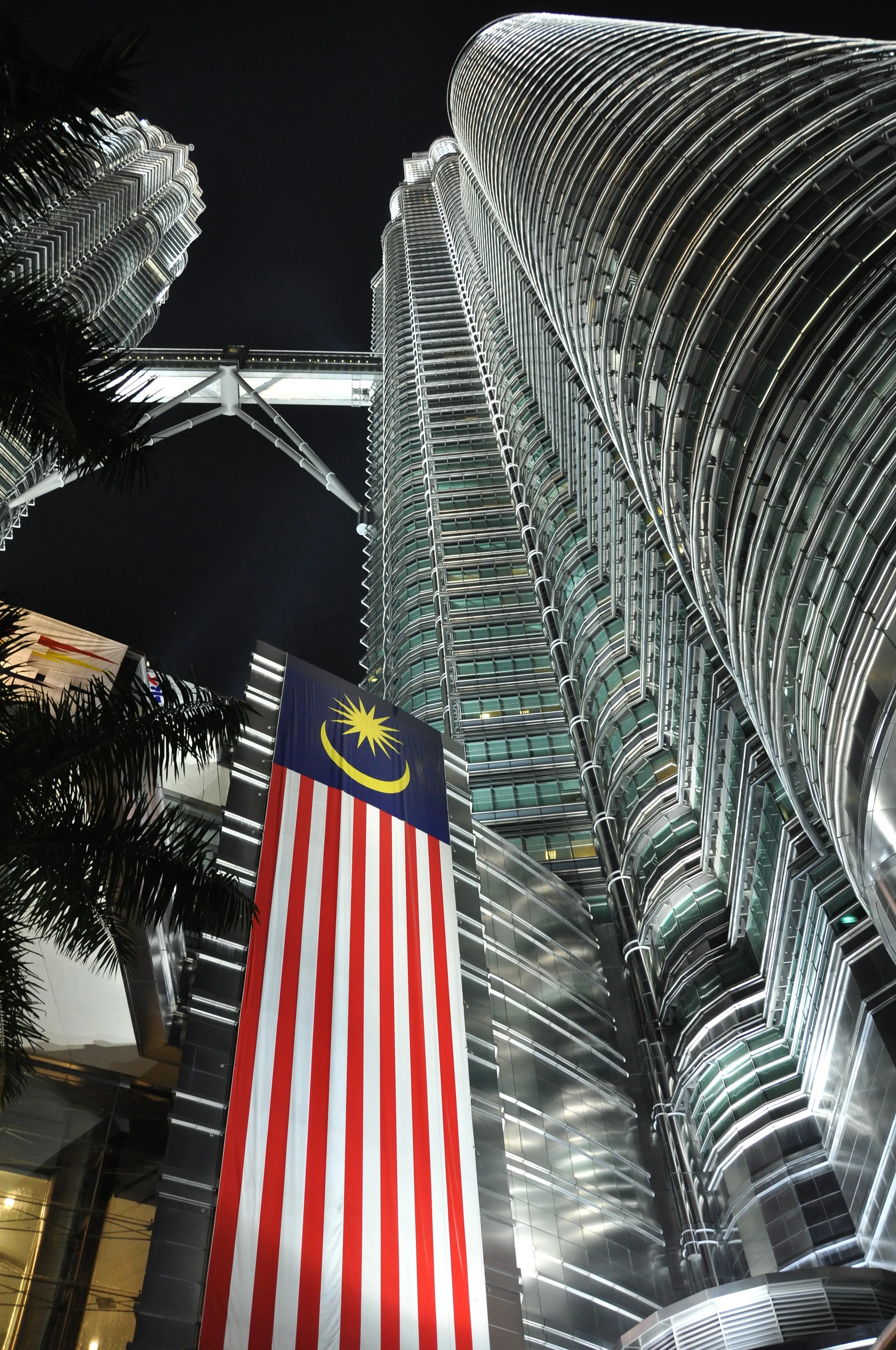 Petronas Twin Towers rising above the Kuala Lumpur skyline at dusk