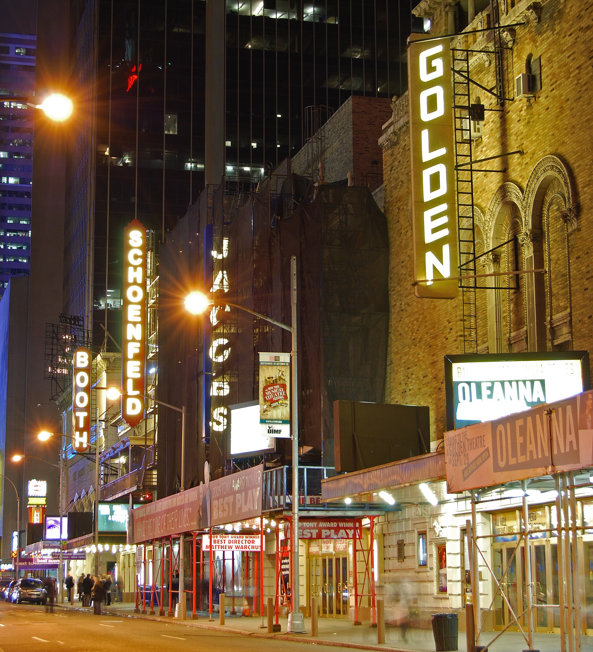 Broadway theaters on West 45th Street at night with illuminated marquees