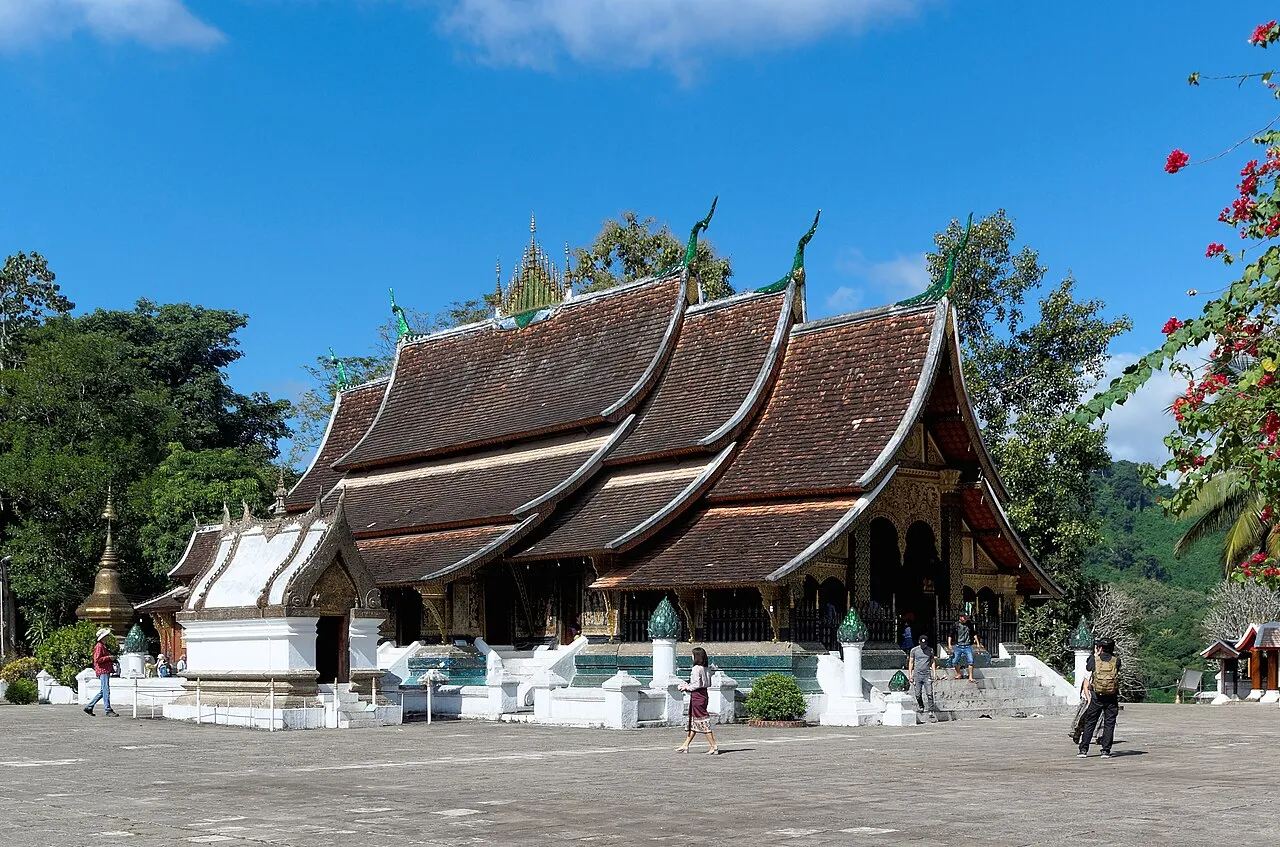 Multi-tiered sweeping roofs of Wat Xieng Thong temple in Luang Prabang at sunset