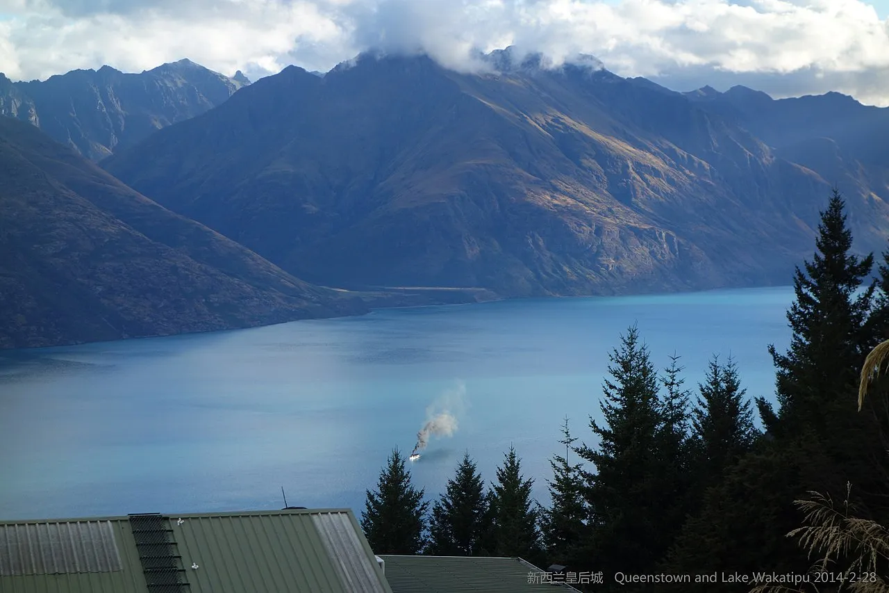 TSS Earnslaw vintage steamship sailing on Lake Wakatipu with the Remarkables mountains behind, Queenstown New Zealand