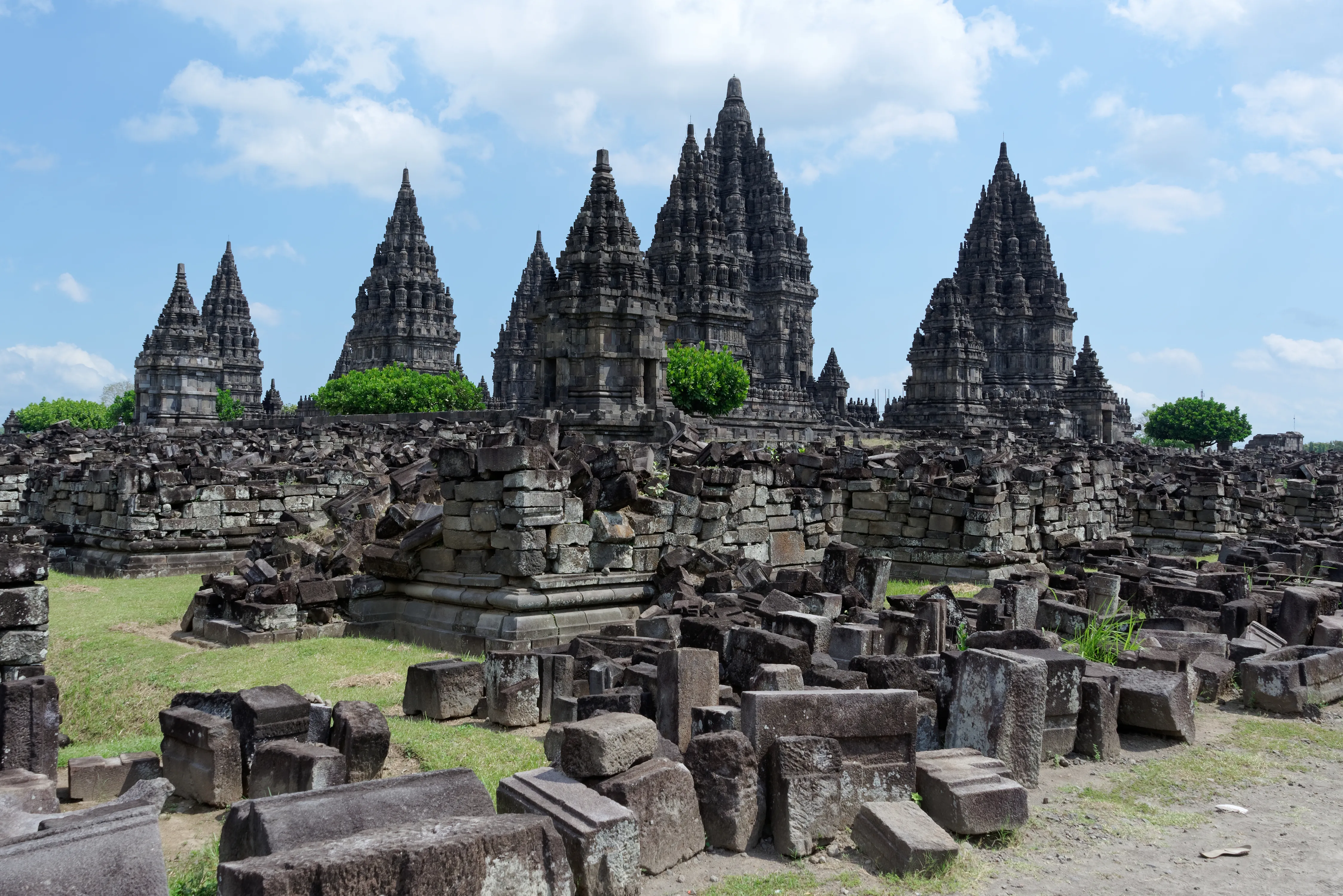 Prambanan Hindu temple compound with towering spires rising against a blue sky, Yogyakarta, Java, Indonesia