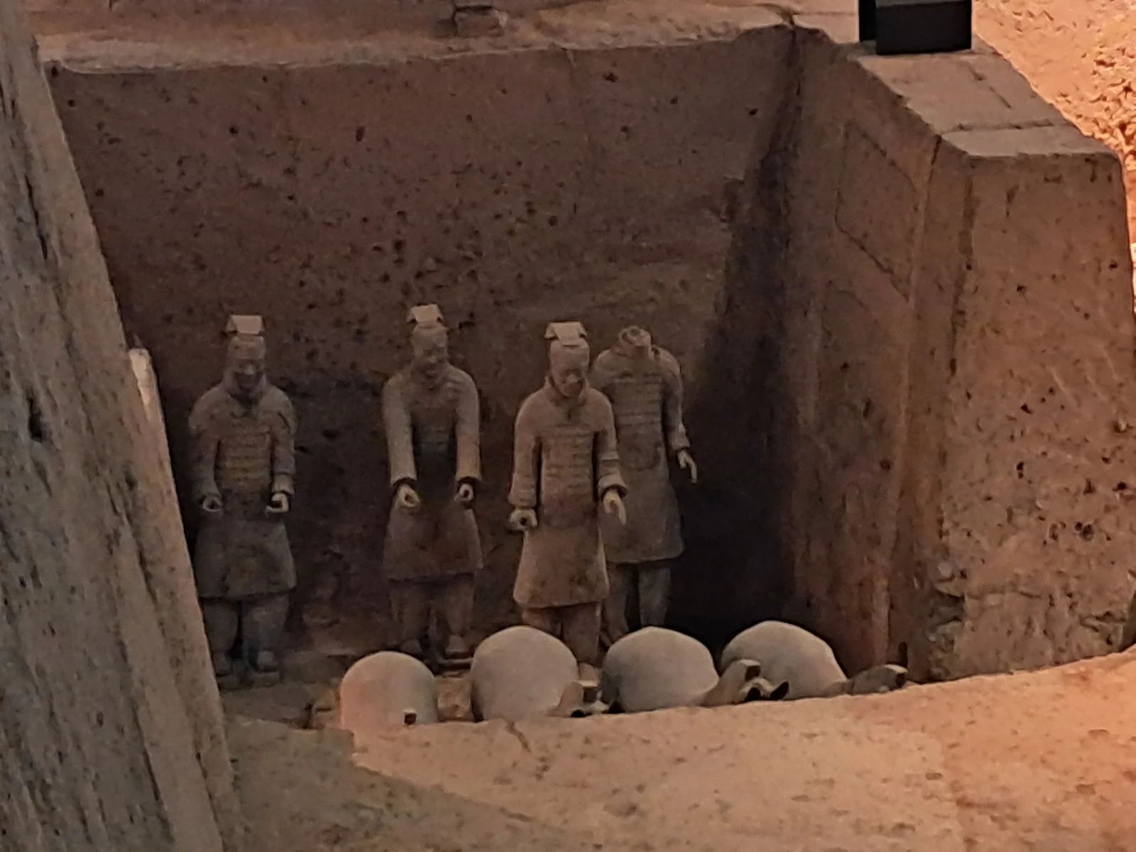 Close view of individually modelled terracotta infantrymen with distinct faces and topknots near Xi'an