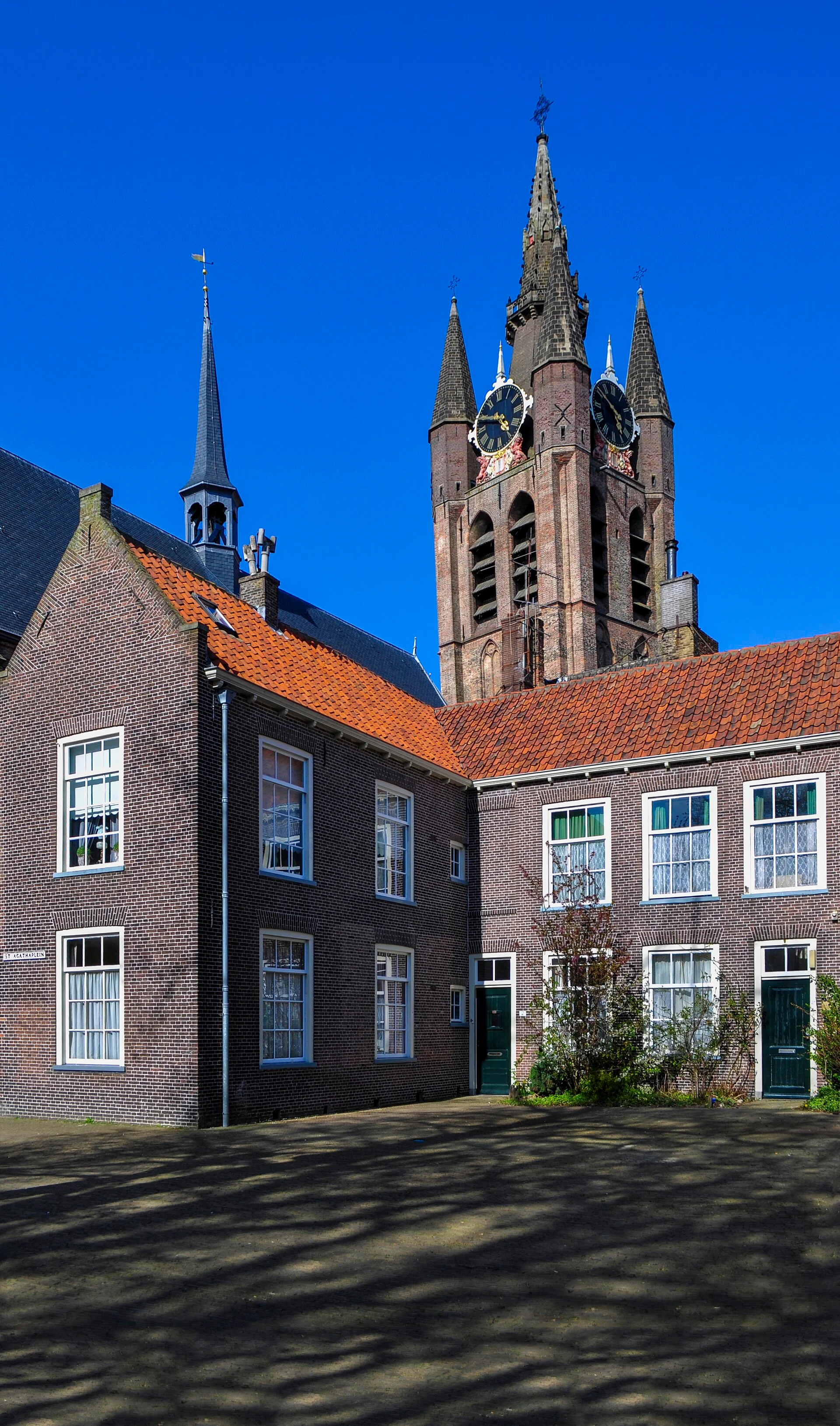 Leaning brick tower of the Oude Kerk seen from St Agathaplein