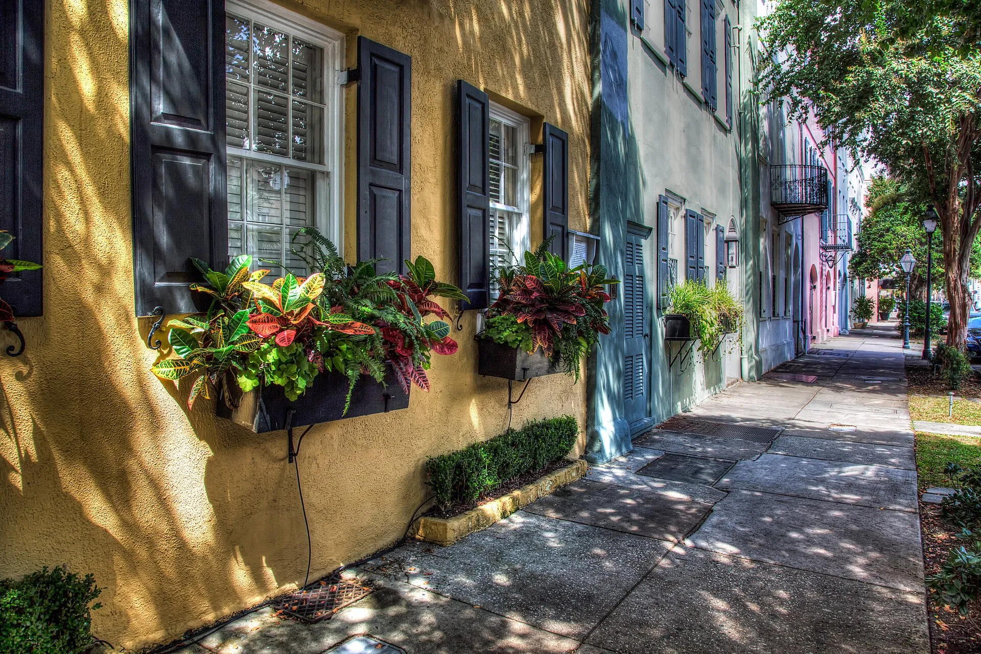 Wide-angle view of the pastel-colored Georgian rowhouses of Rainbow Row on East Bay Street in Charleston