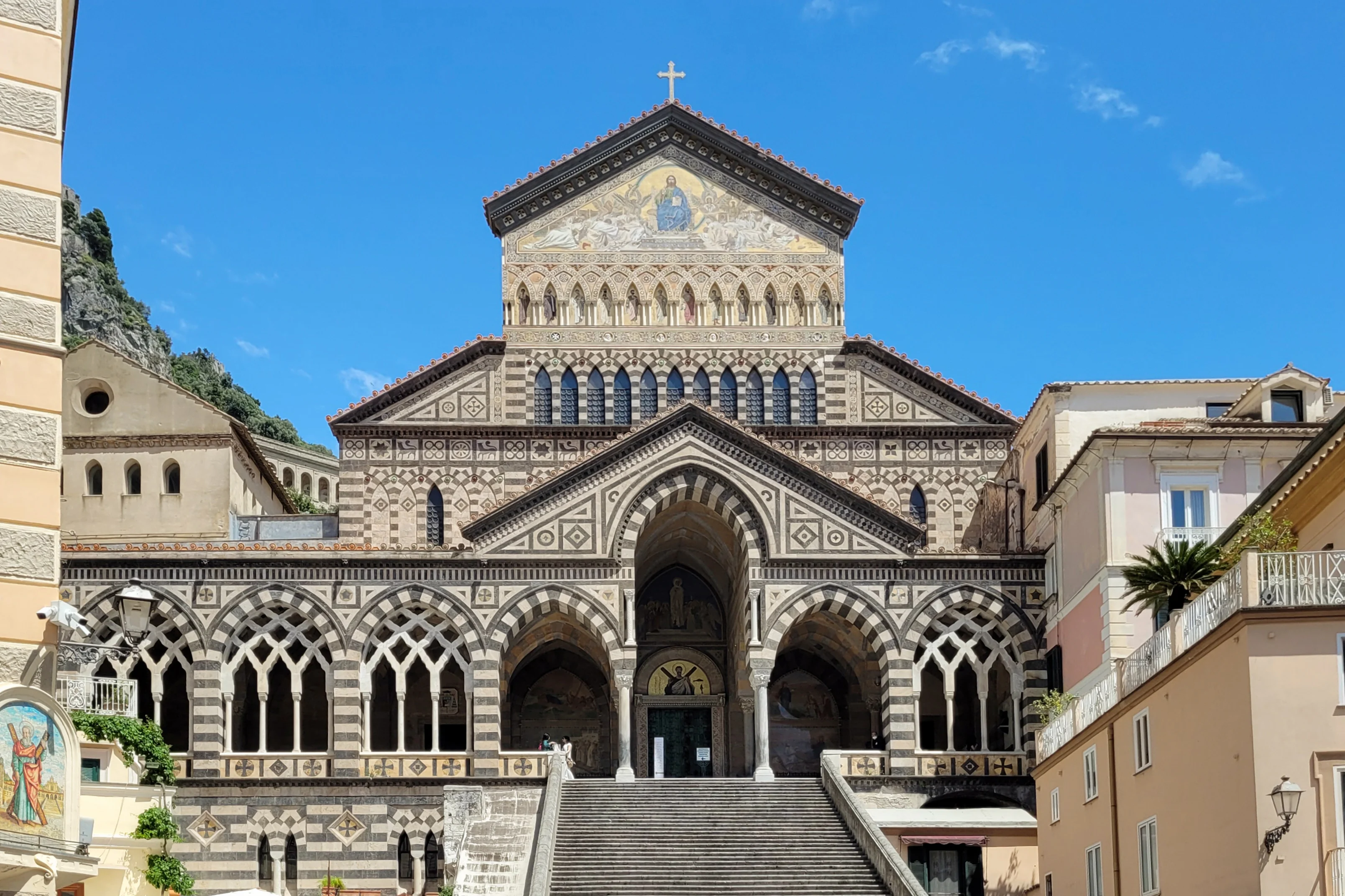 The striped Arab-Norman facade and steep staircase of Amalfi Cathedral in the town's main piazza