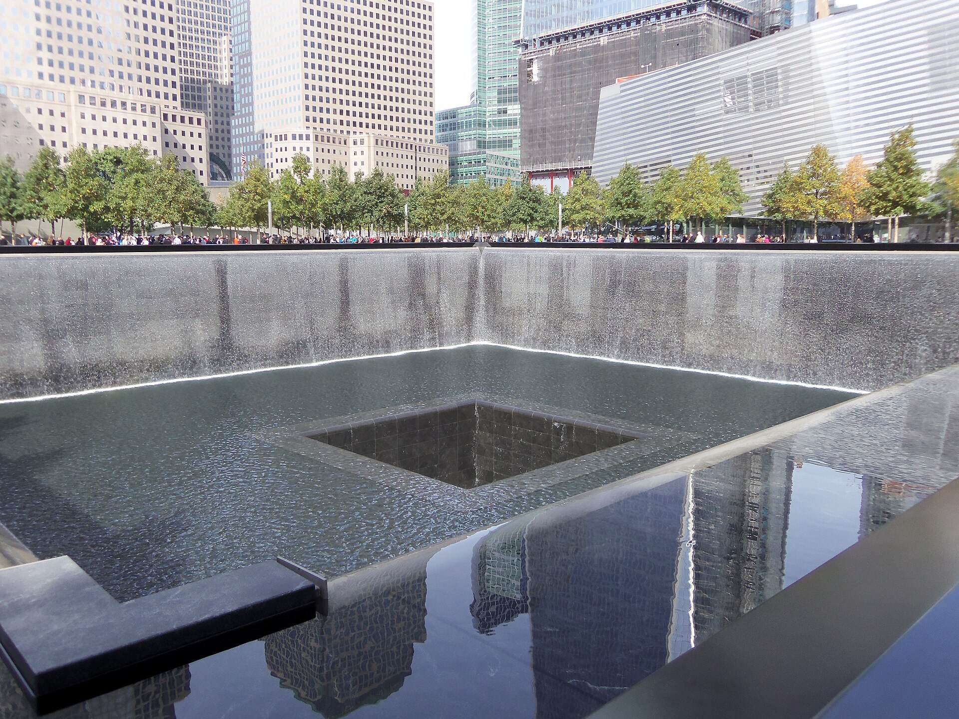 The South Pool of the National September 11 Memorial with names of victims inscribed around the bronze parapets
