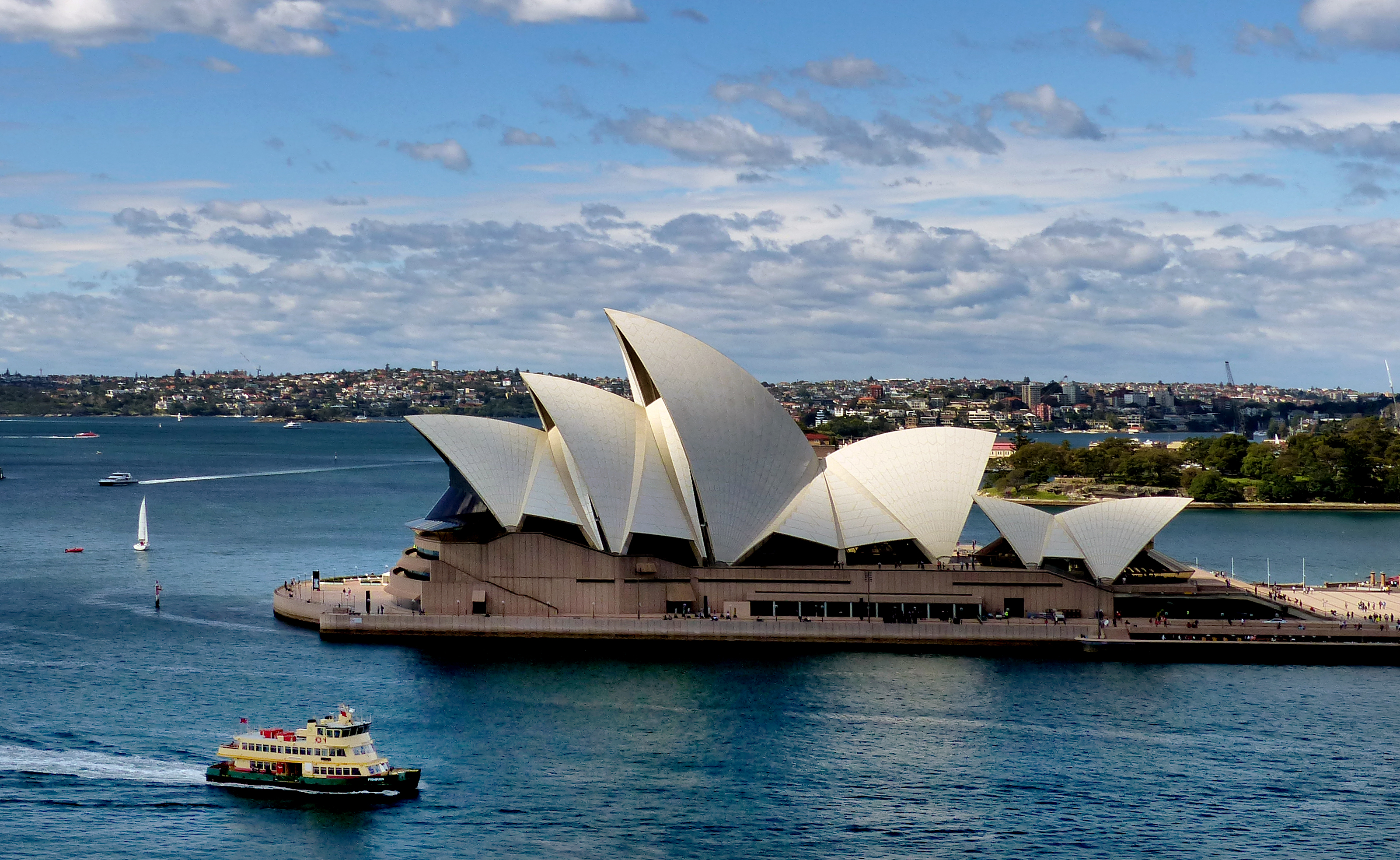 Sydney Opera House shell vaults seen from the Royal Botanic Gardens across Farm Cove
