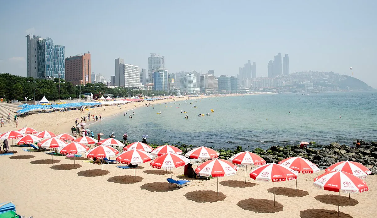 Haeundae Beach in Busan, South Korea, showing the wide sandy shoreline and beachfront skyline