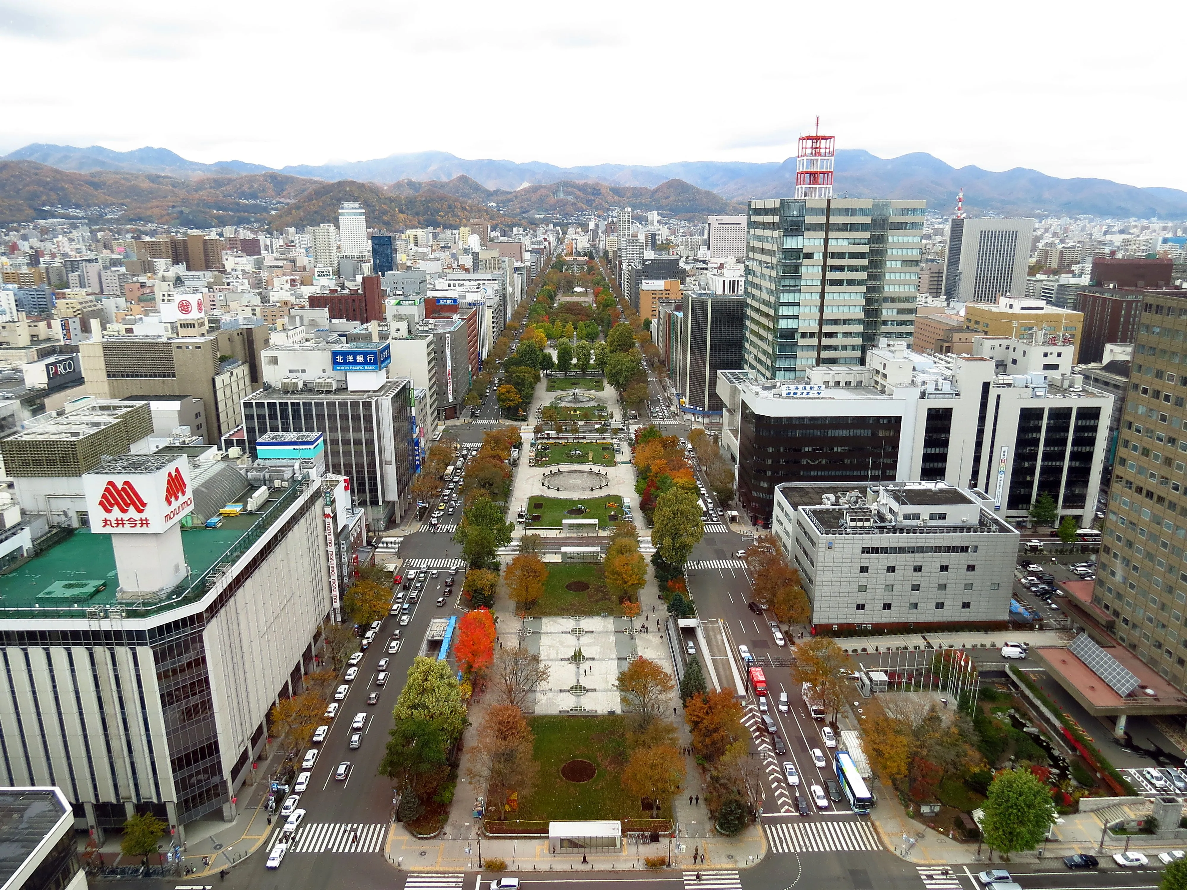 Lawns, flower beds and trees stretching down the green ribbon of Odori Park toward the Sapporo TV Tower