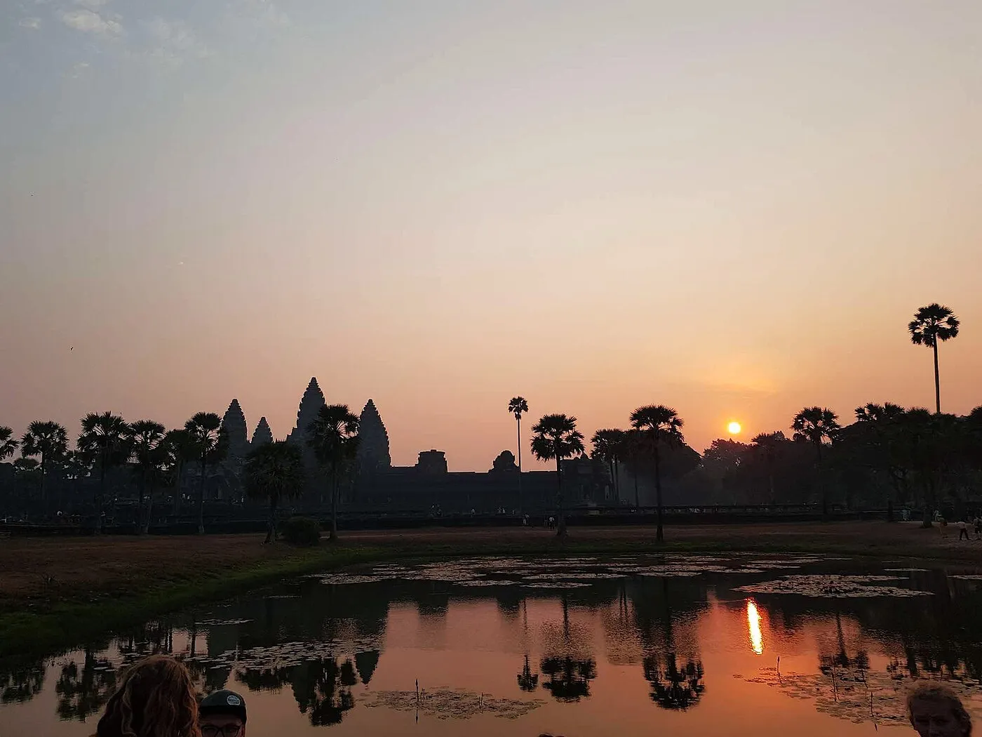 Angkor Wat temple complex surrounded by jungle and reflected pools in Cambodia