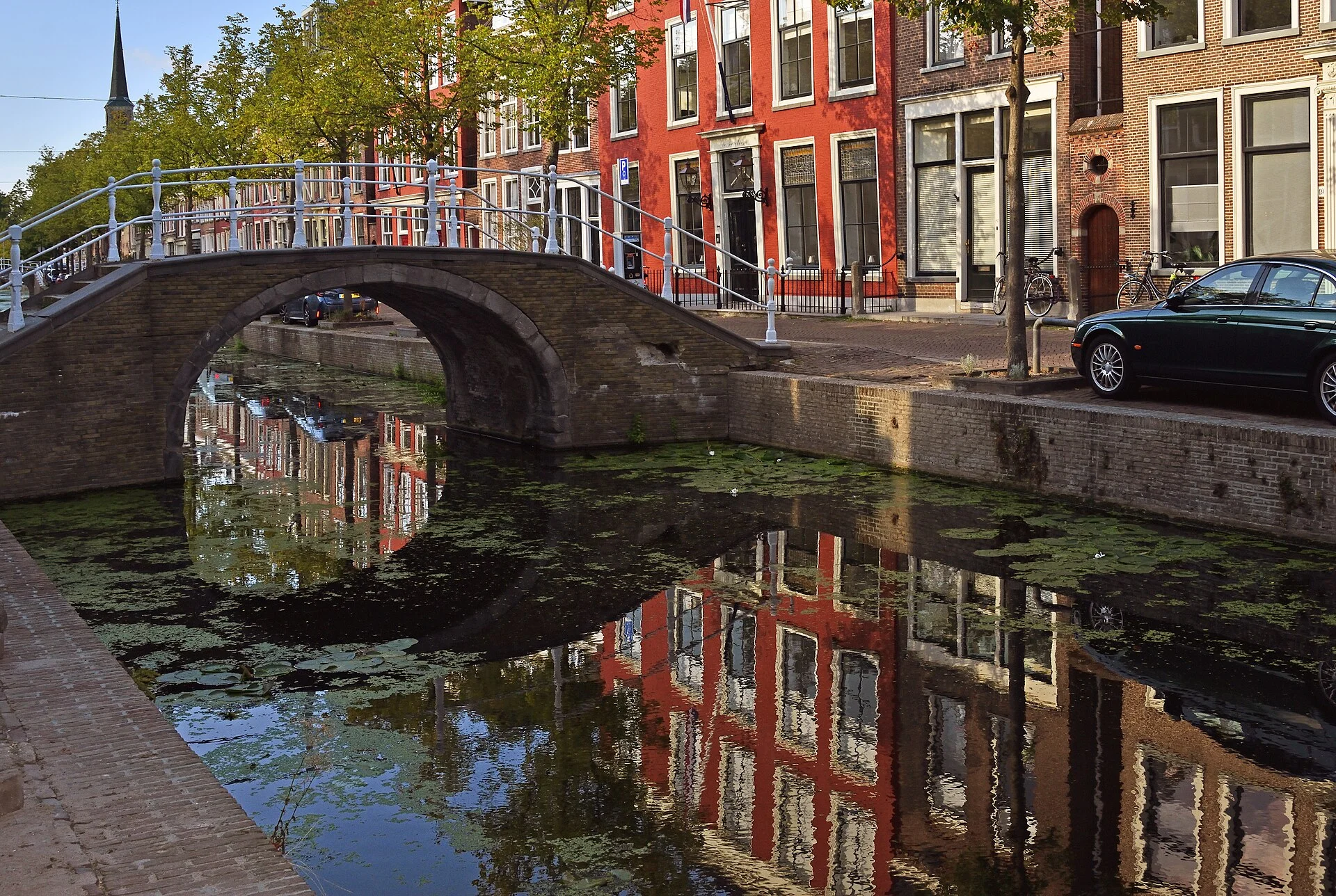 Arched stone footbridge over the Oude Delft canal in Delft