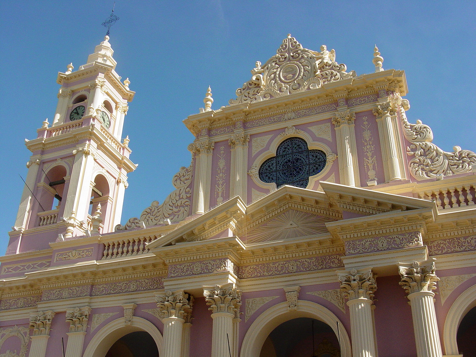 The ornate pink and white facade of Salta Cathedral in the historic center of Salta, Argentina