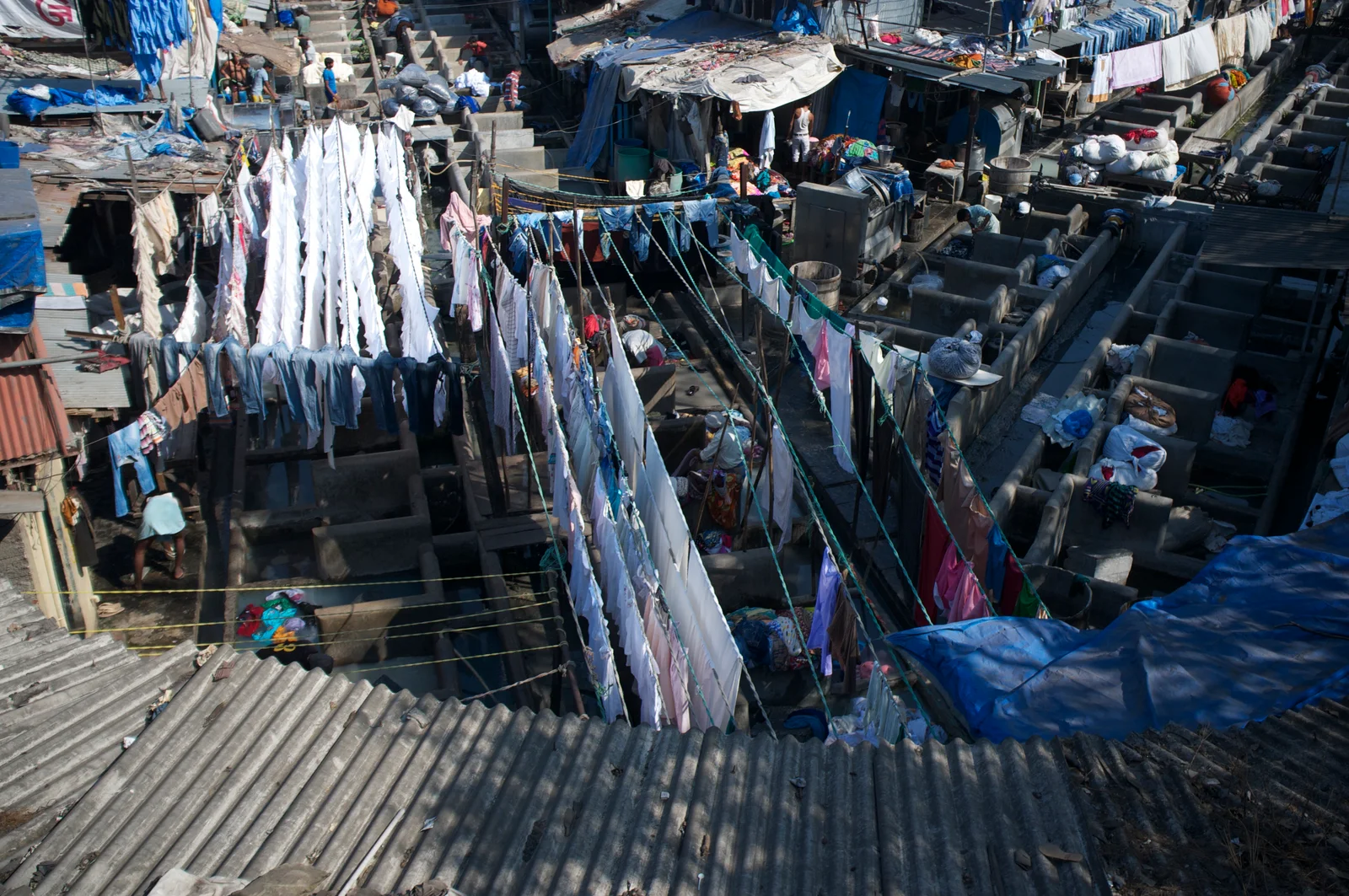 Rows of open-air concrete washing pens at Mumbai's Dhobi Ghat