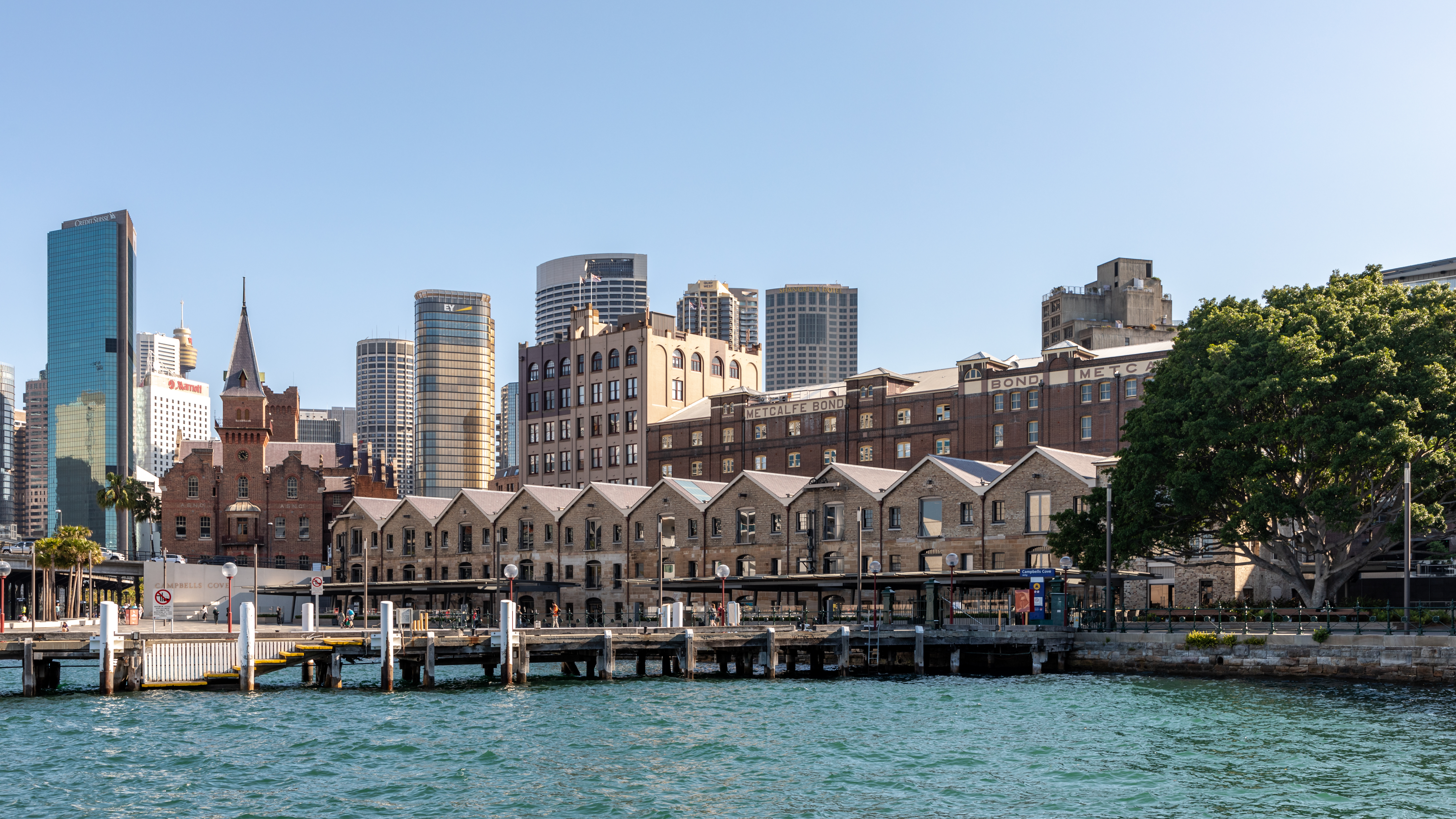 The Rocks neighbourhood in Sydney with historic sandstone buildings below the Harbour Bridge