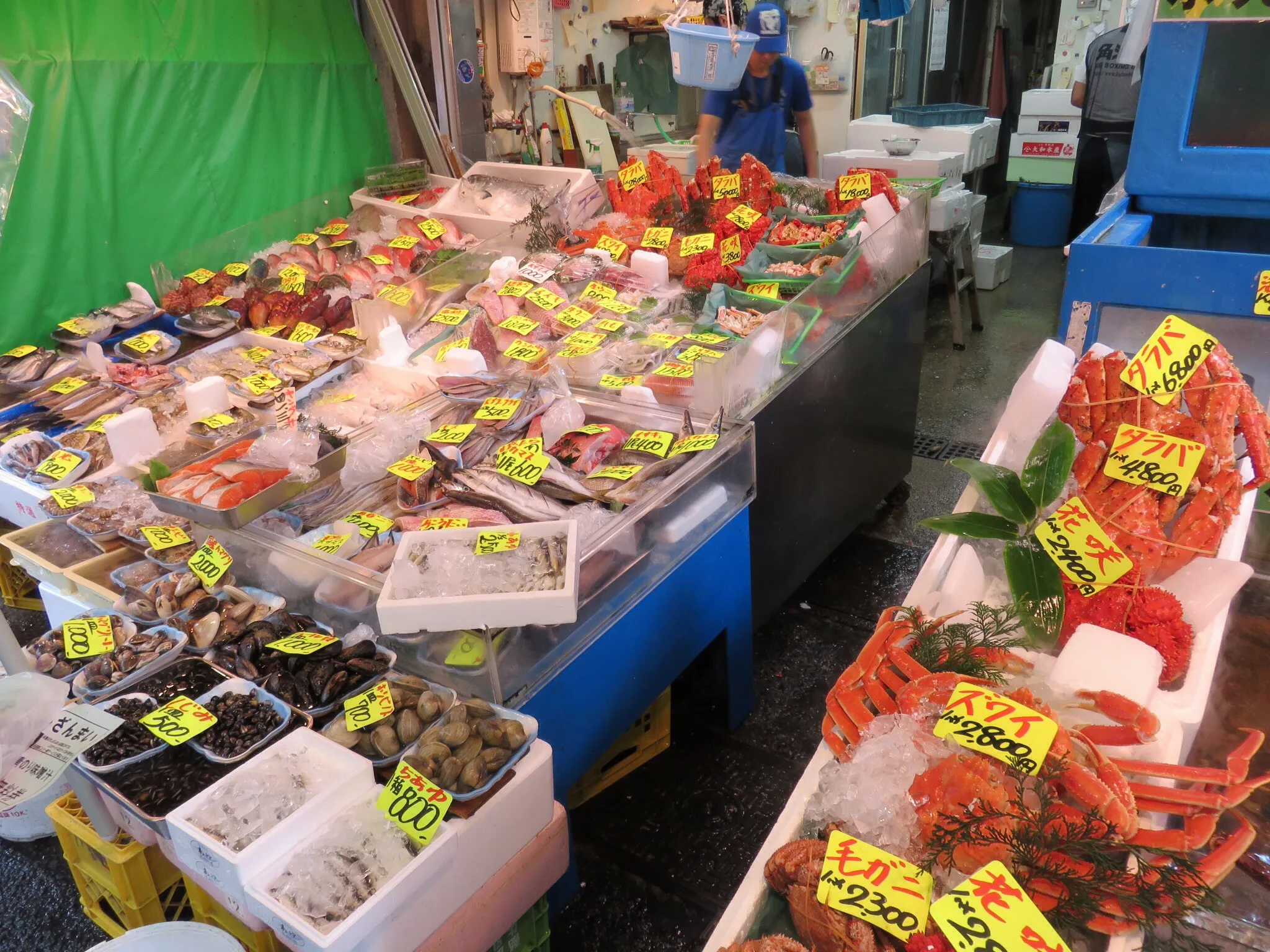 Shoppers browsing the narrow stall-lined lanes of the Tsukiji Outer Market in Tokyo