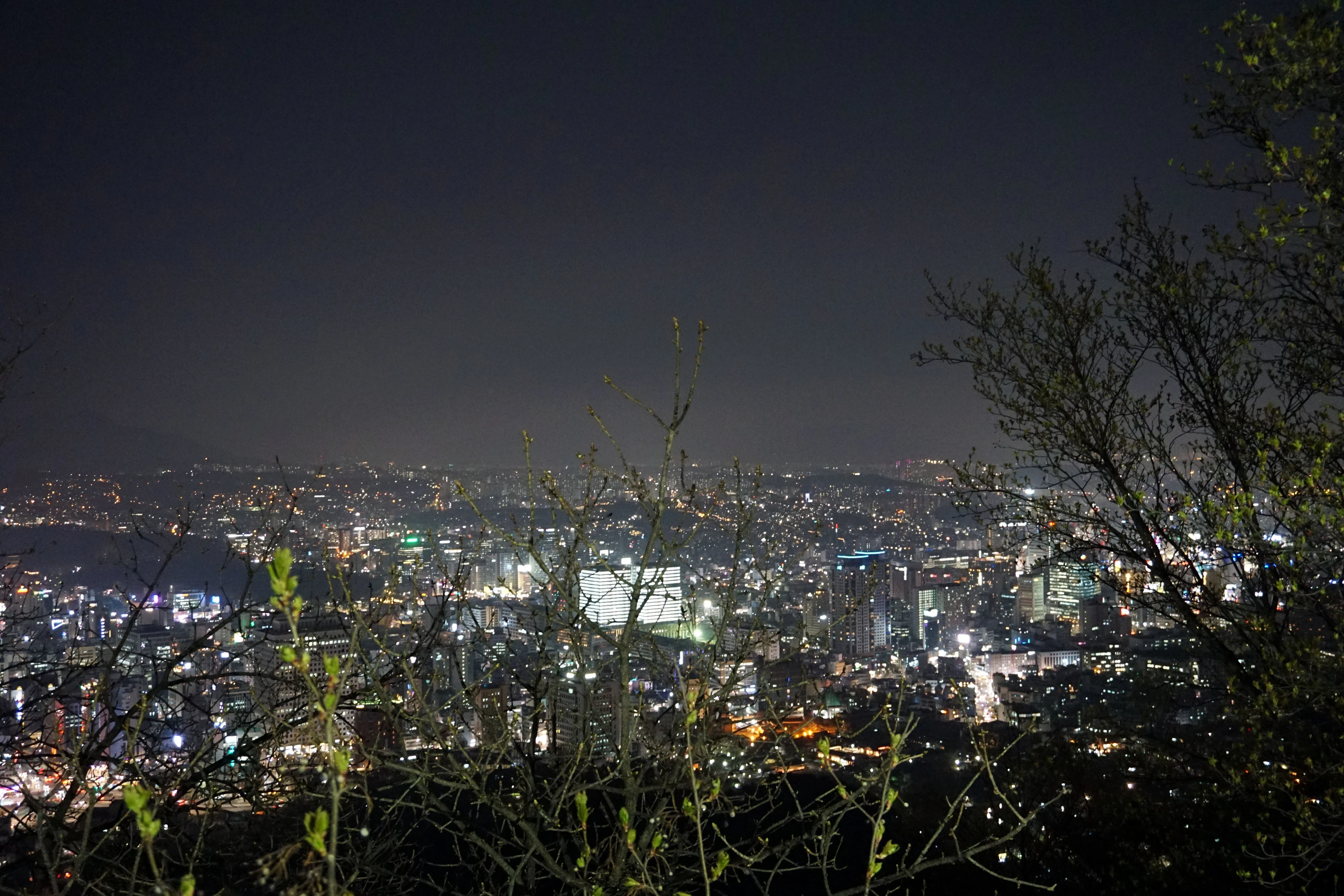 Seoul city montage showing the Han River skyline, Gyeongbokgung Palace, and Bukchon Hanok Village rooftops