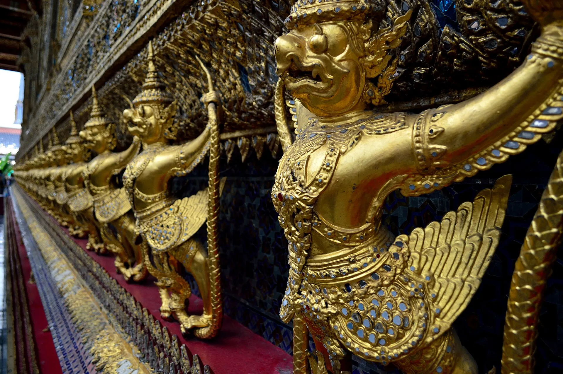 Row of golden garuda figures at Wat Phra Kaew