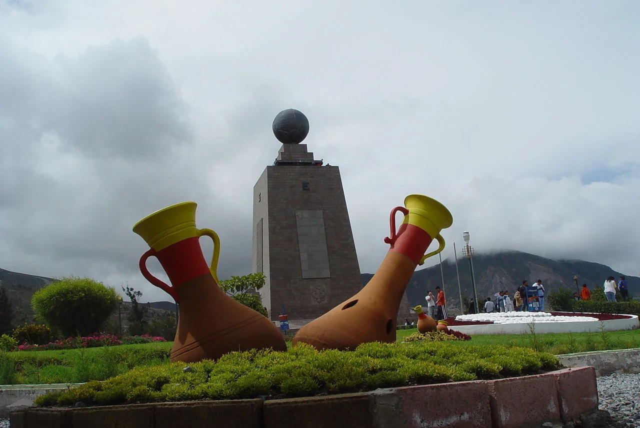 The Mitad del Mundo monument and yellow line marking the equator at the Middle of the World complex near Quito, Ecuador