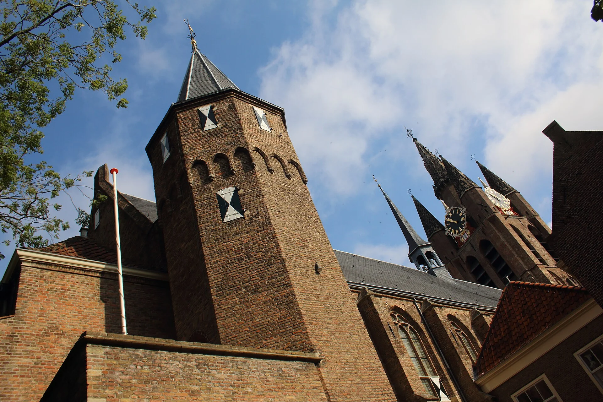 Brick tower of Museum Prinsenhof with the Nieuwe Kerk spire behind