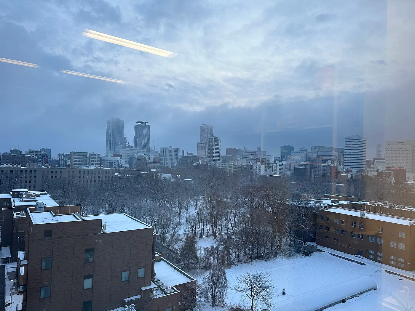 Sapporo city skyline with buildings and mountains in the background, Hokkaido, Japan